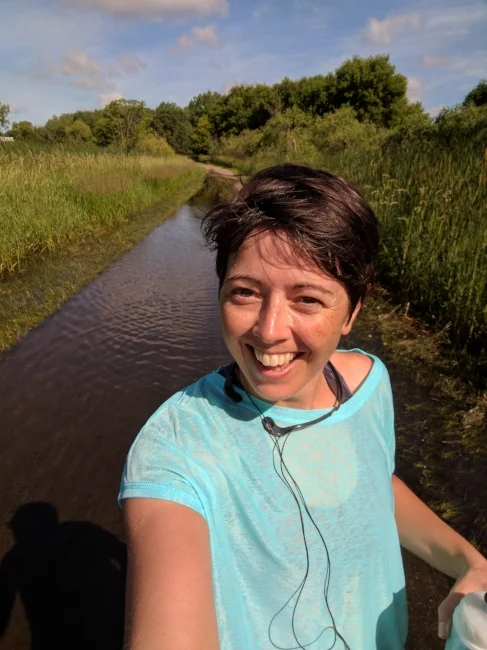 Nope, that's not a river behind me; it's the bike path! It rained pretty hard last night so this is what happened. Lots of red-winged blackbirds flitted around the cattails on both sides of the path as I ran by.