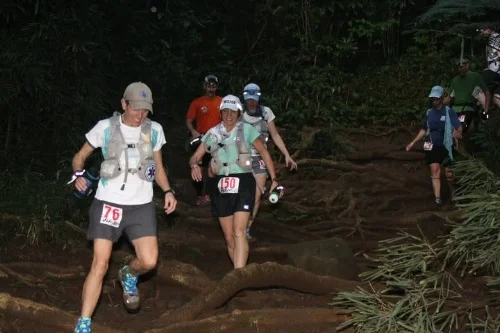 Sarah leads us through a very rooty part of the trail. Photo by Akabill Ultrarunner.