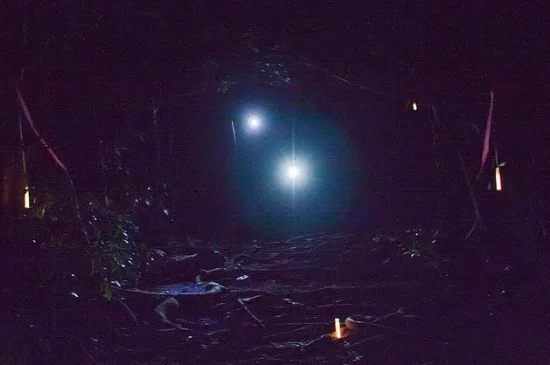 Is this me and Sue? Some other runner and his or her pacer? It doesn't really matter; this is what we all looked like on loop 3, negotiating the rugged, muddy, rooty trails in the dark. Photo by Robert P. Smith.