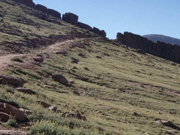 After cresting the first big ascent, the trail levels out a bit. We also spot our first glacier! Ahead, a red-rock spine becomes our next "rest stop" goal destination.