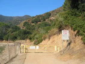 Climb around this ugly yellow metal gate, and you're good to go!