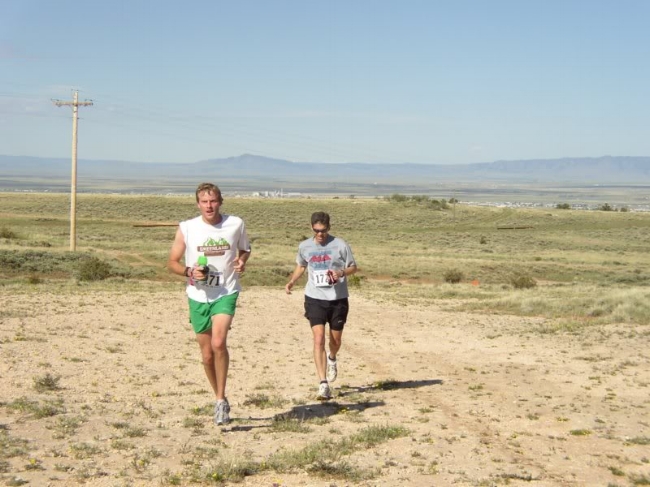 Brian Martisius and Patrick Eastman run toward the middle aid station at a blistering pace.