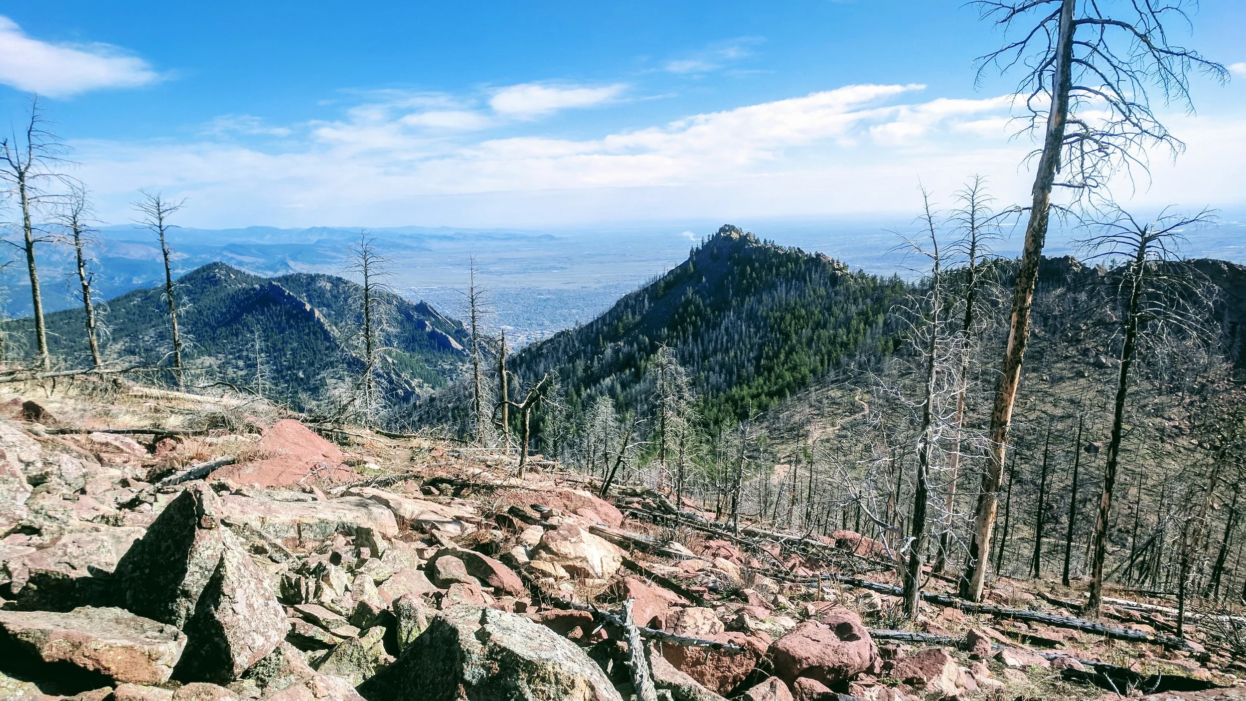 After tagging the summit, retrace your steps back down this rocky north flank of South Boulder Peak to the trail junction, and continue straight up a few rocky switchbacks toward Bear Peak.