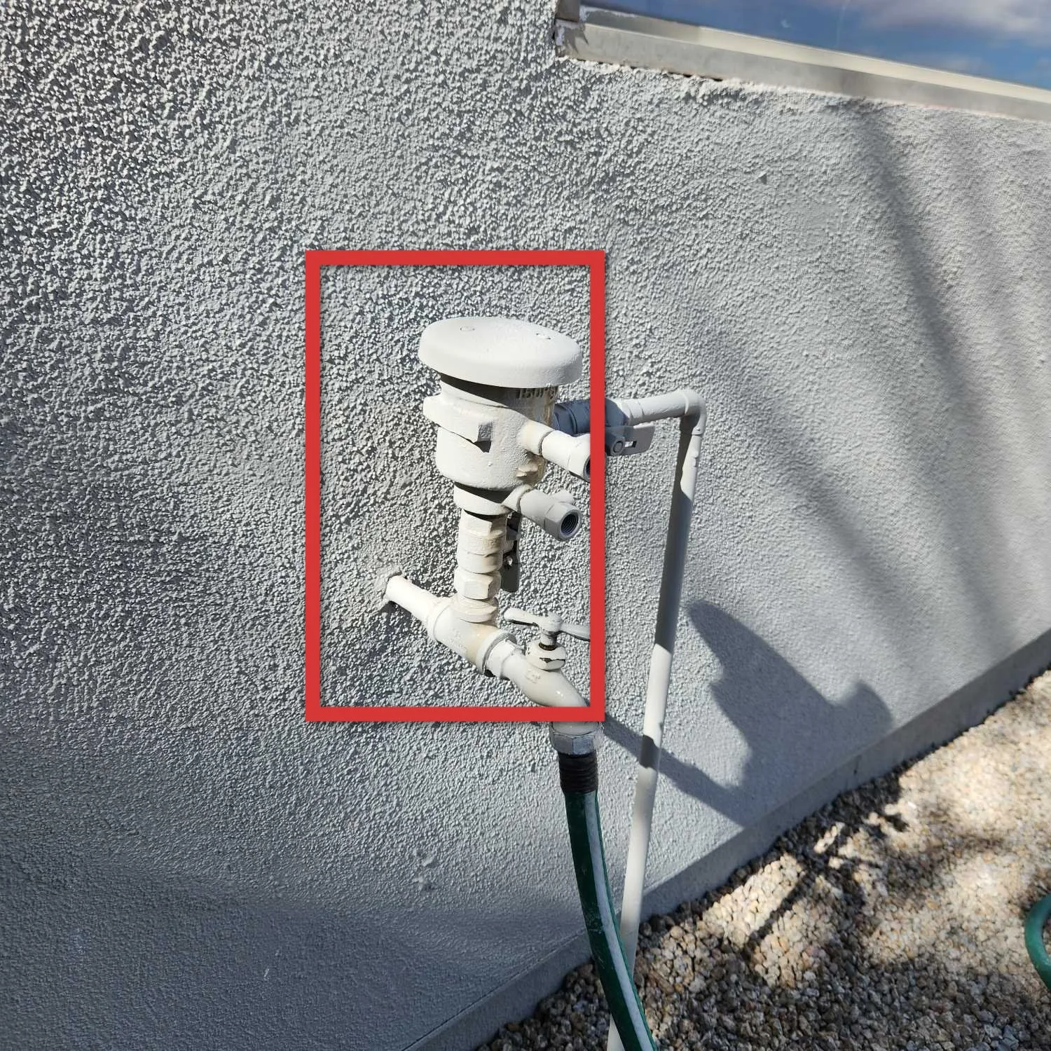red box highlighting a damaged anti-siphon valve on an Arizona pool