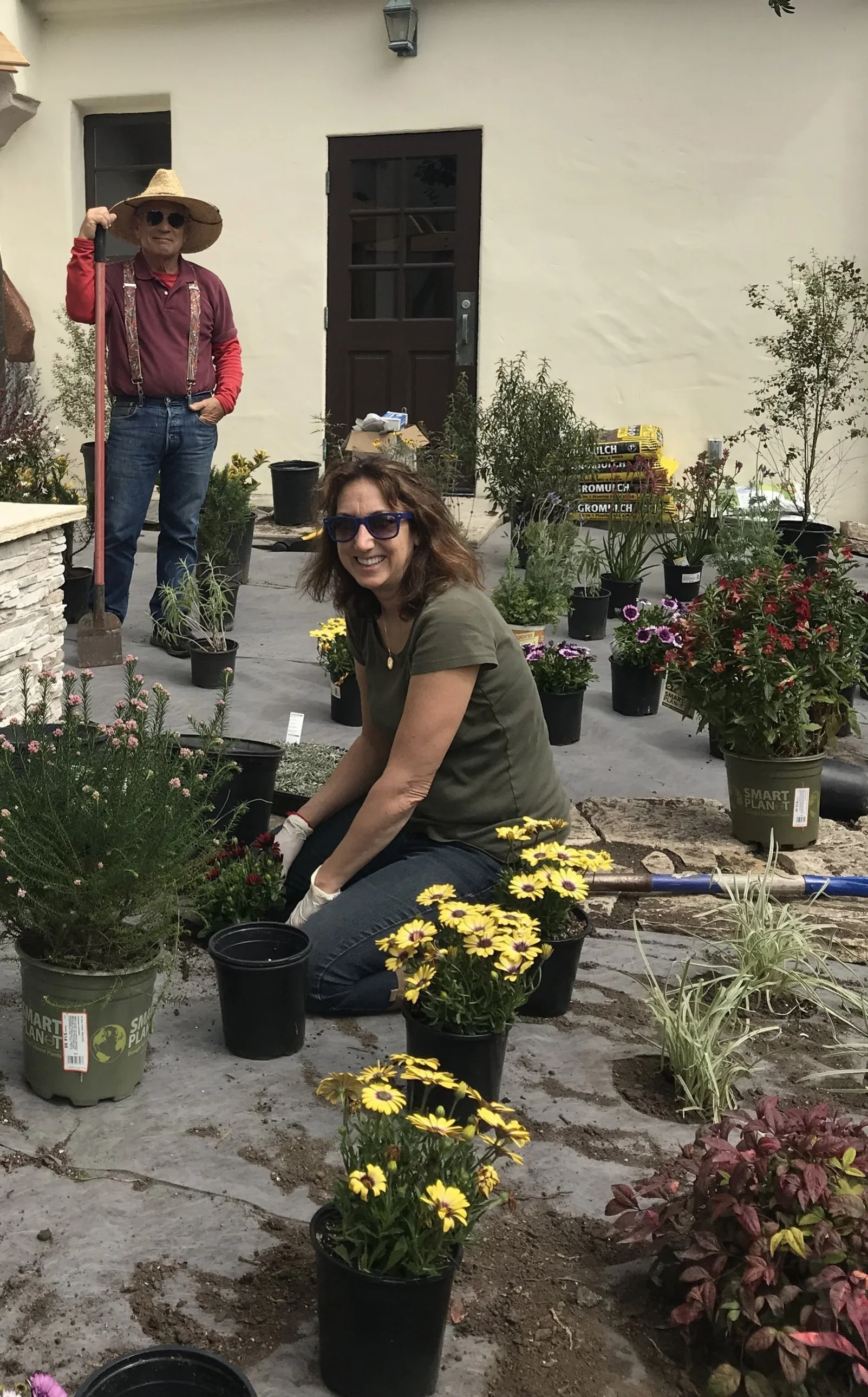 Doug Falzetti and Laurie Jester helping out with the planting of plants and flowers in the garden. 