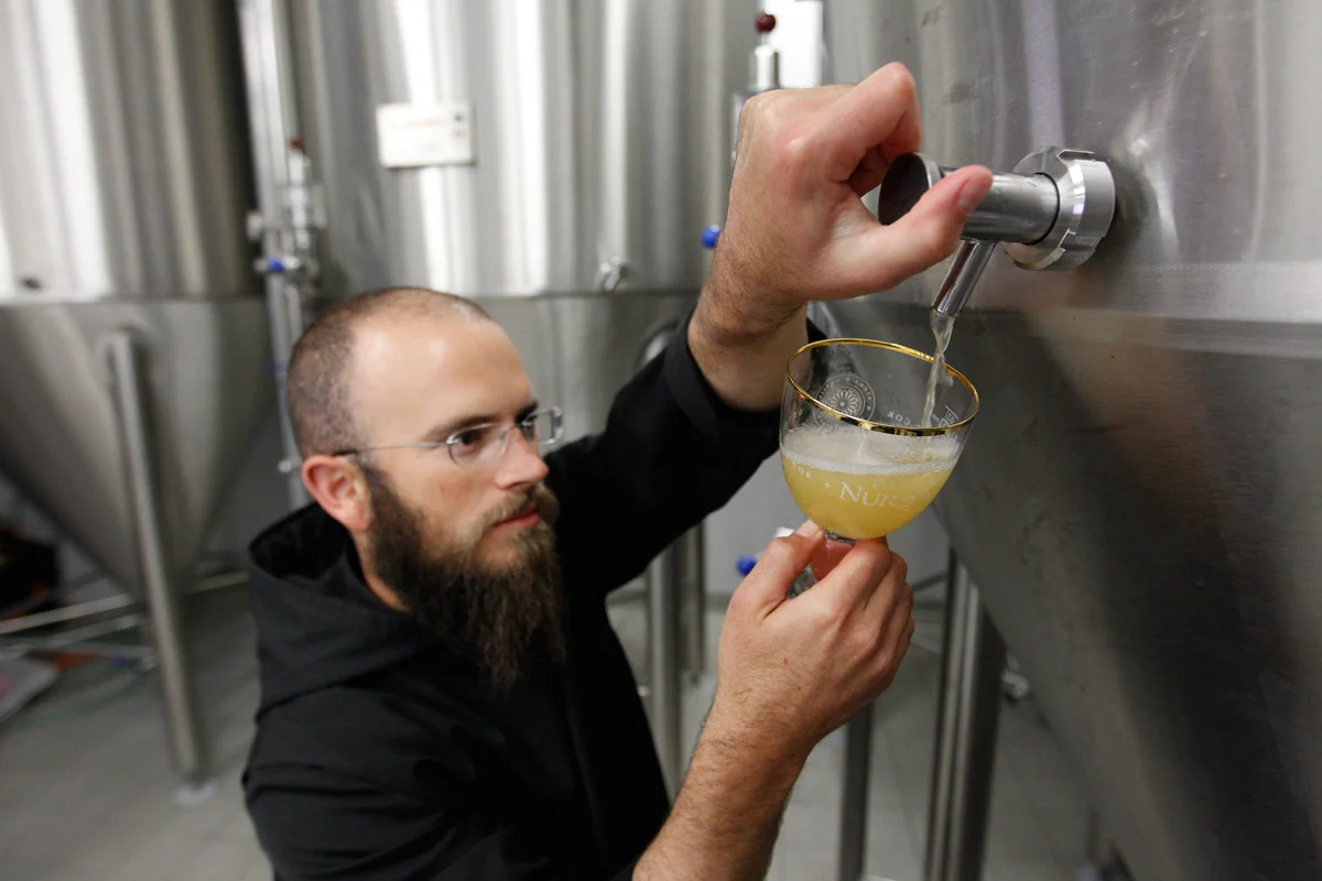 Father Martin taste-testing the beer