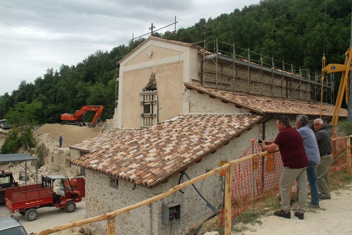 Clearing rubble from the old Franciscan church and convent, where the monks will begin anew.