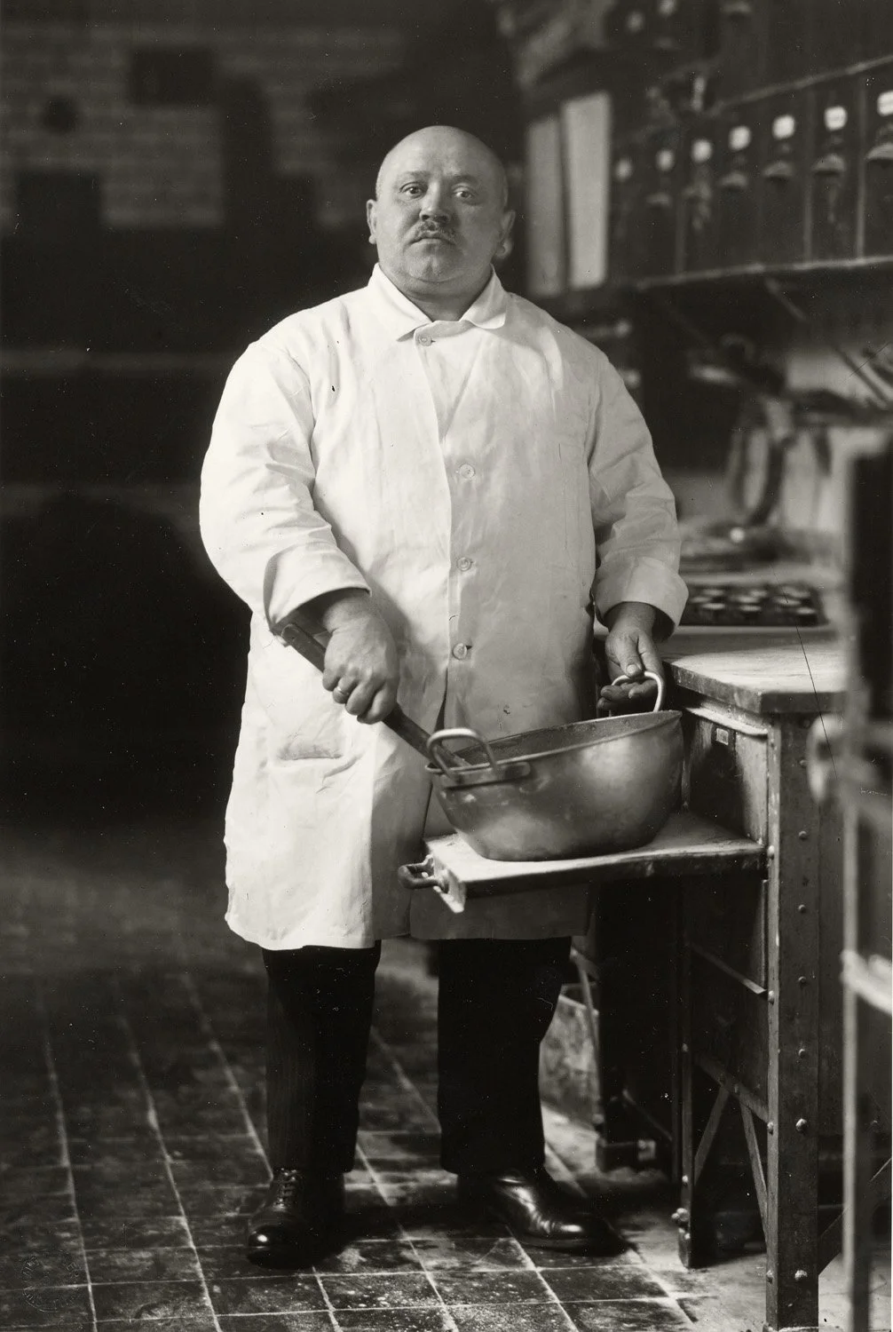  August Sander (German, 1876-1964)   The Pastrycook , 1928 Stamped, editioned, and signed by Gerd Sander on print verso Blind stamp on lower right print recto Gelatin silver print, printed from the original negative by artist's grandson, Gerd Sander 