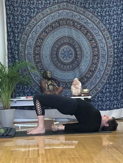 Taking a second round, this time remove the block and interlace the hands behind the back. Draw the shoulder blades in, lifting through the chest, pressing the outer edges of the baby fingers into the mat. Hold for 2-3 minutes.