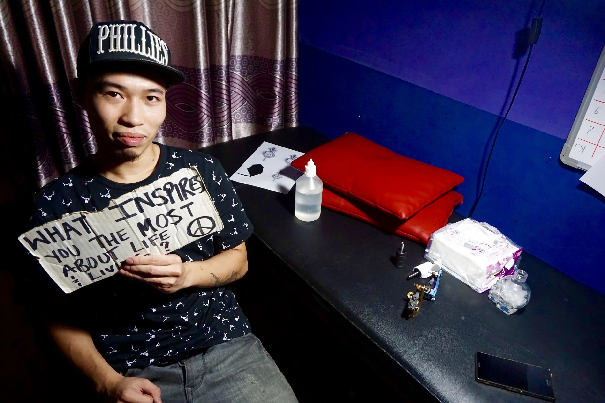 From : Vietnam Interview Location : Hanoi, Vietnam “Bringing happiness to people. I love to see the happy face of everybody, not by me, just happy like… (Khanh then does a quick gesture of walking around with big smile)…First I have to do good tattoos for other people, it’s what I can do now.”