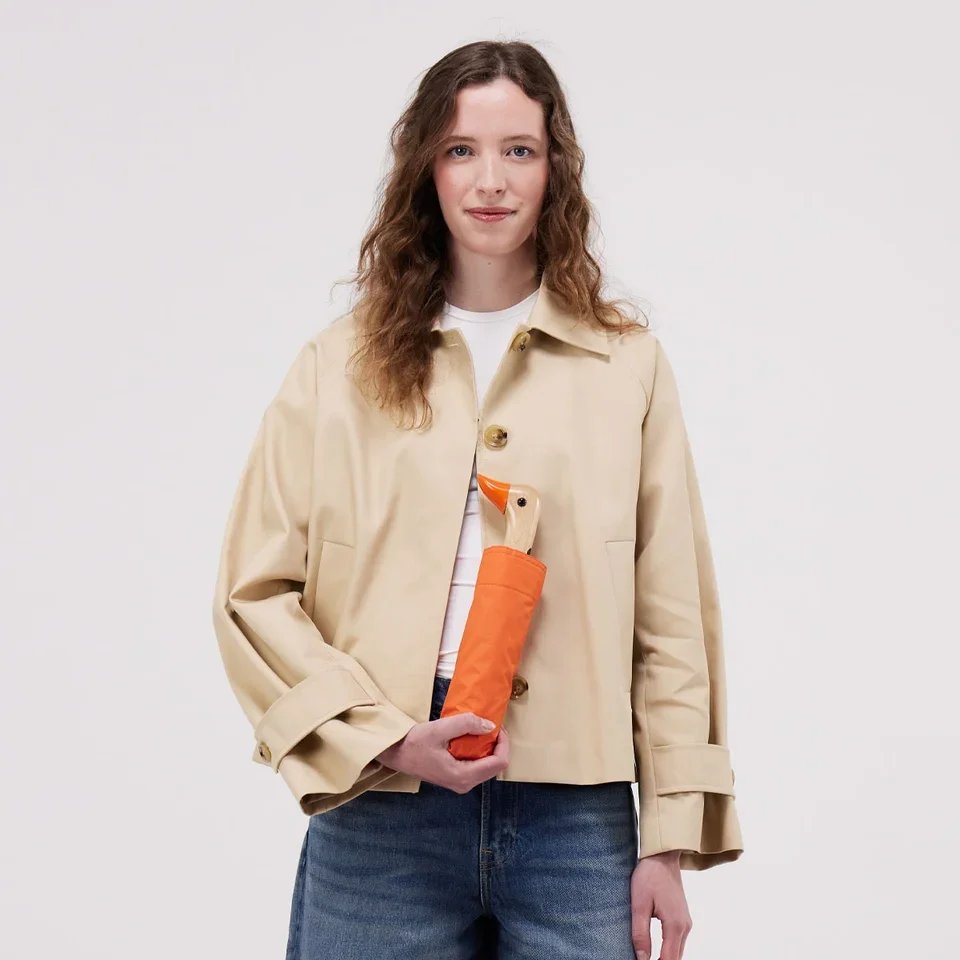 original-duckhead-papaya-duck-umbrella-being-held-closed-by-model-square-1200-x-1200.jpg.webp