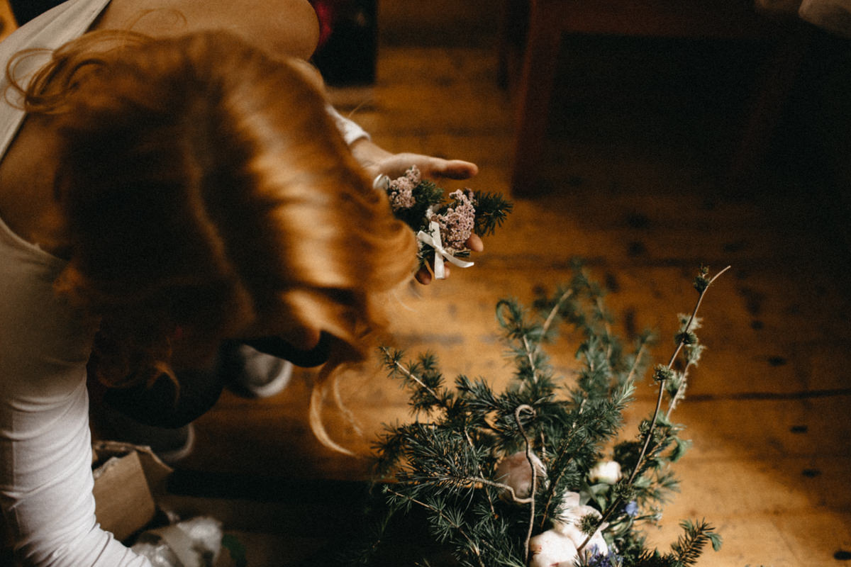 bride collecting wild flowers