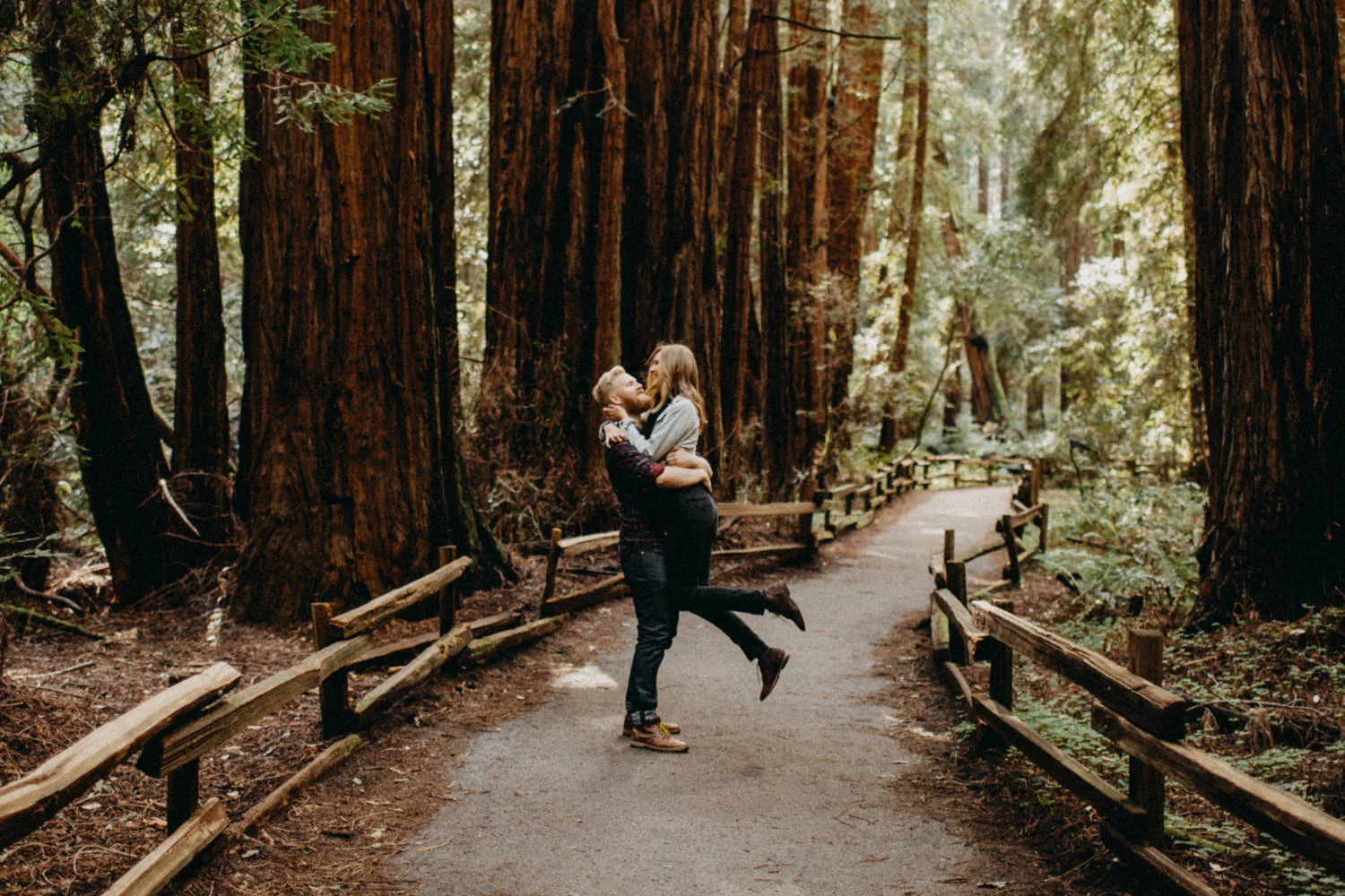 happy couple dancing in the woods
