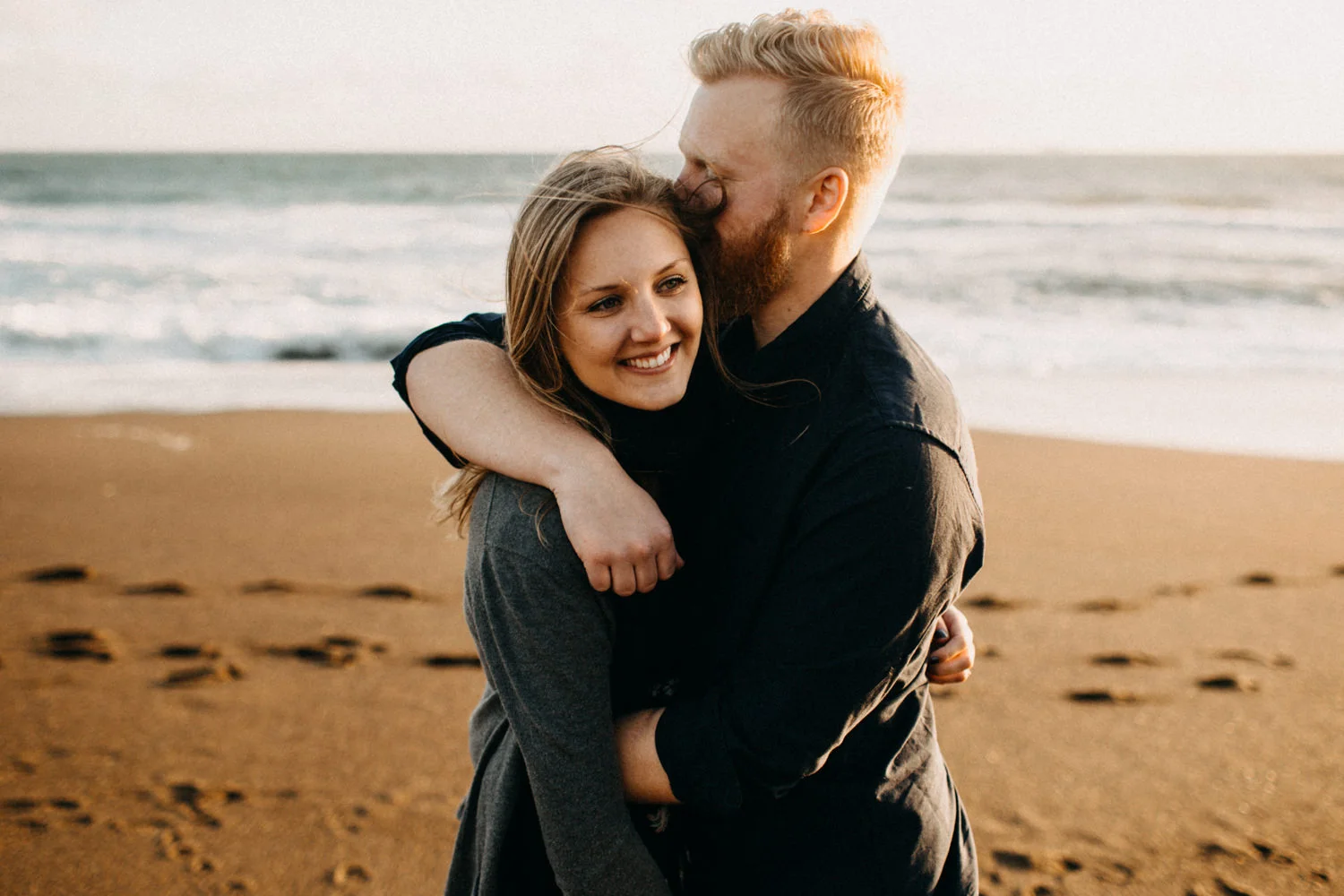 cool couple hugging on the beach
