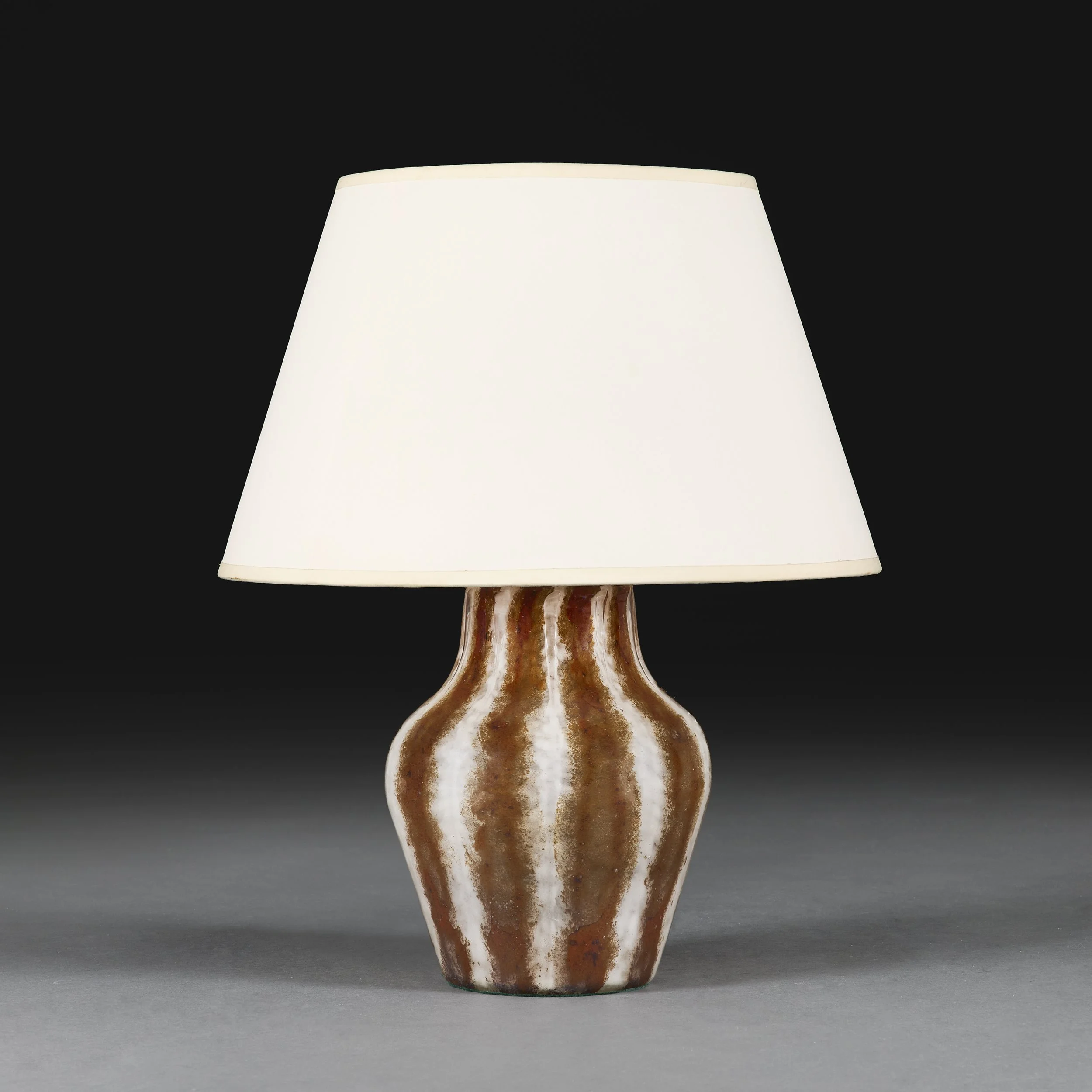 A BROWN AND WHITE STRIPED LAMP