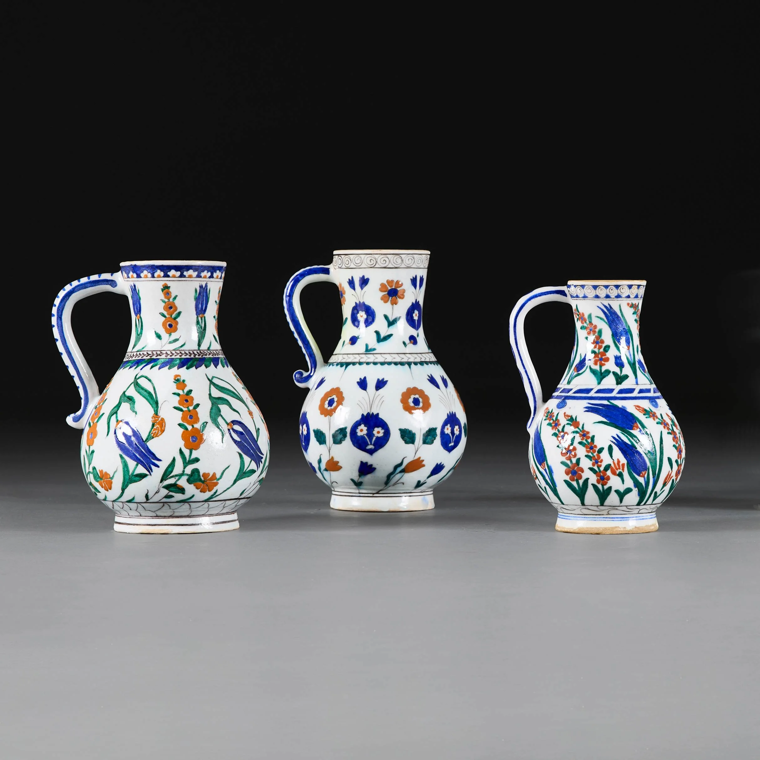 A GROUP OF THREE IZNIK JUGS