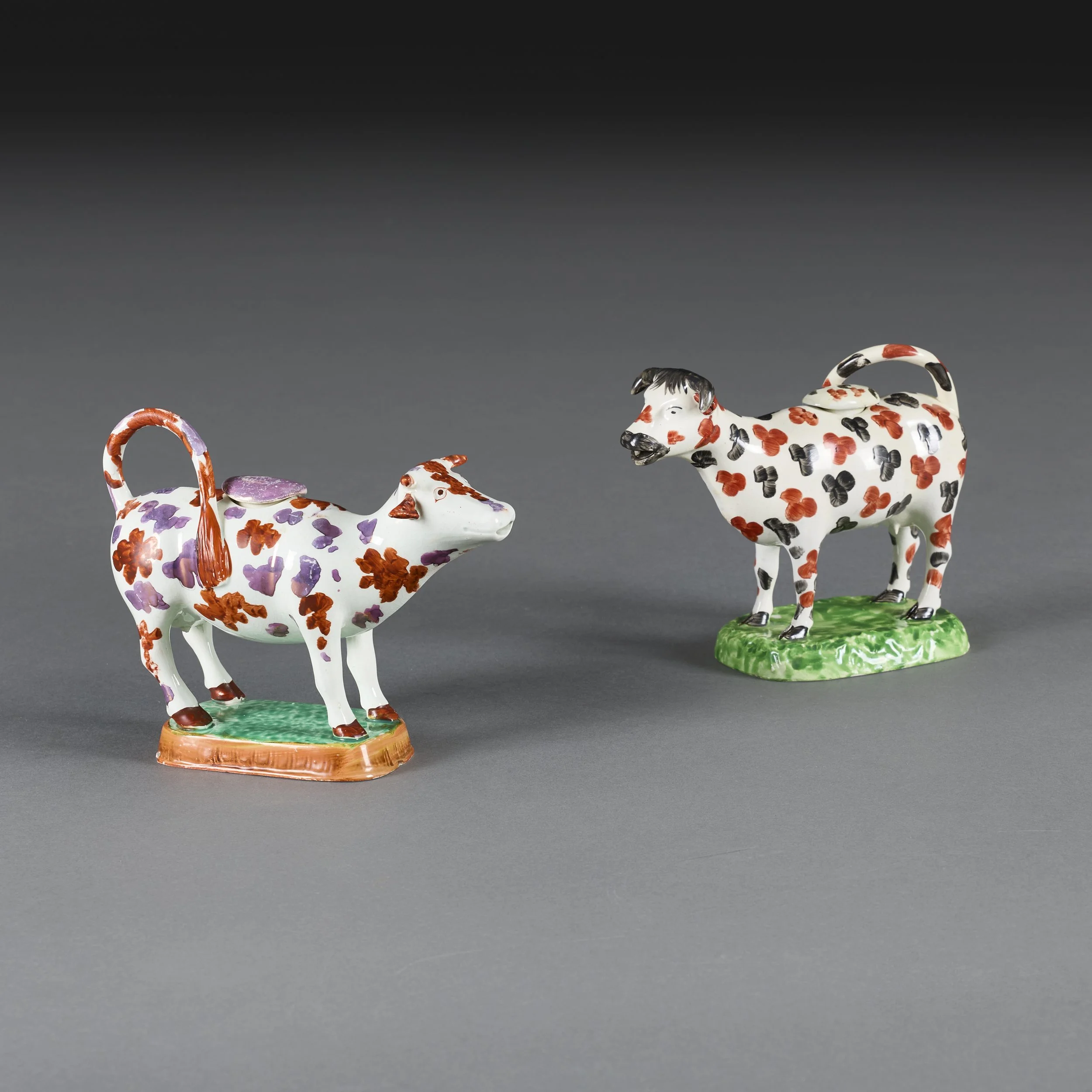 A MATCHED PAIR OF PEARLWARE COW CREAMERS