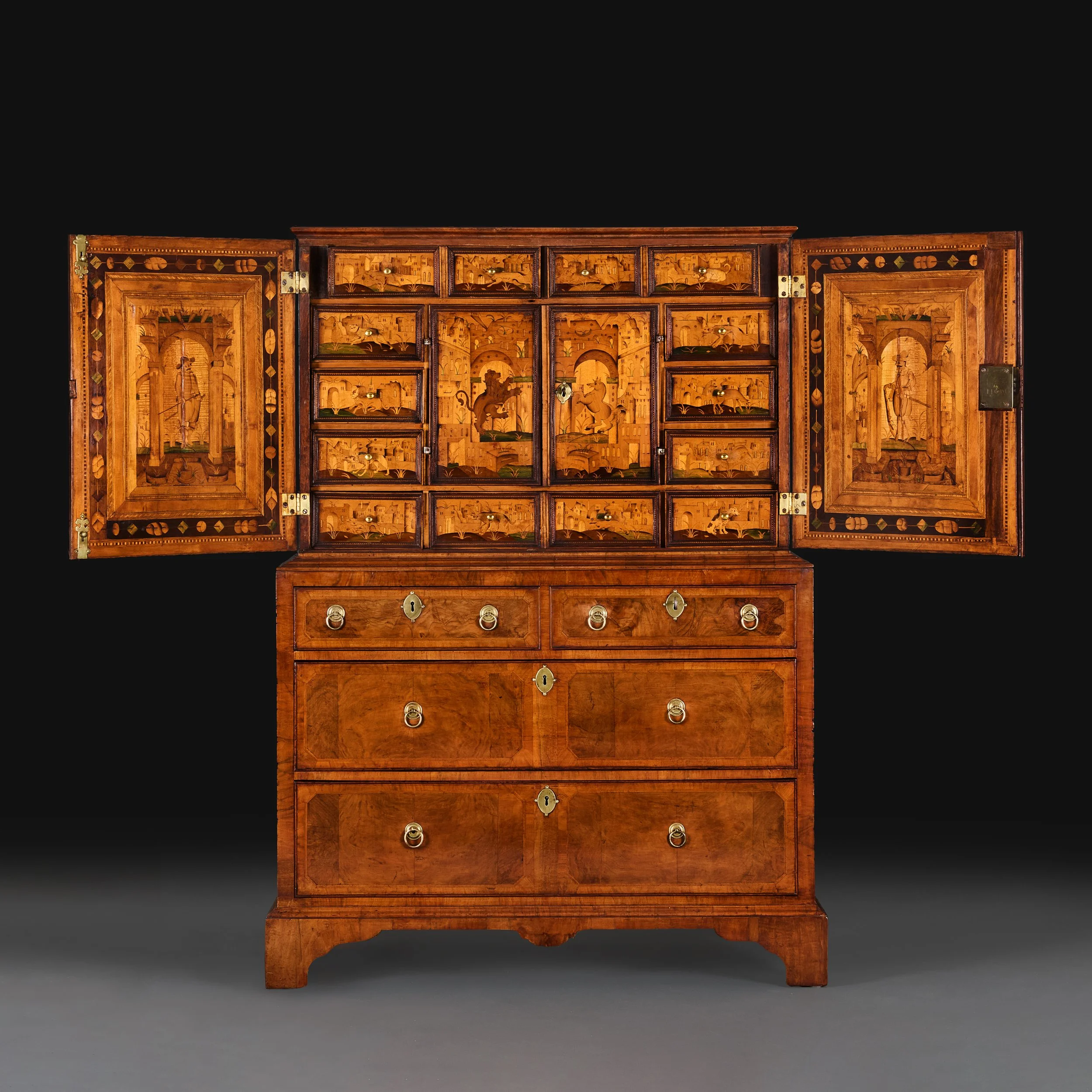 A NORTH EUROPEAN 18TH CENTURY WALNUT CABINET ON CHEST