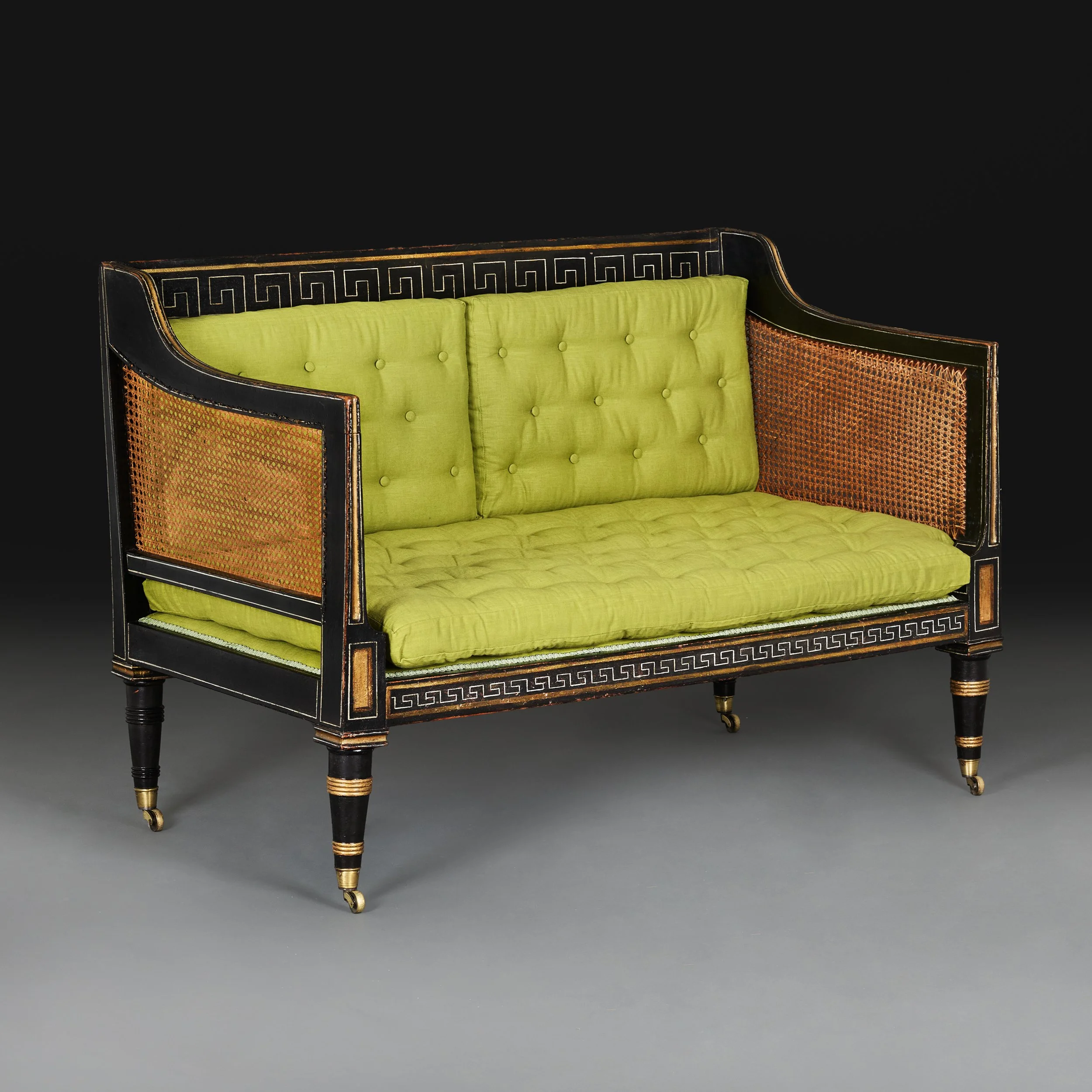 A FINE EBONISED REGENCY SOFA