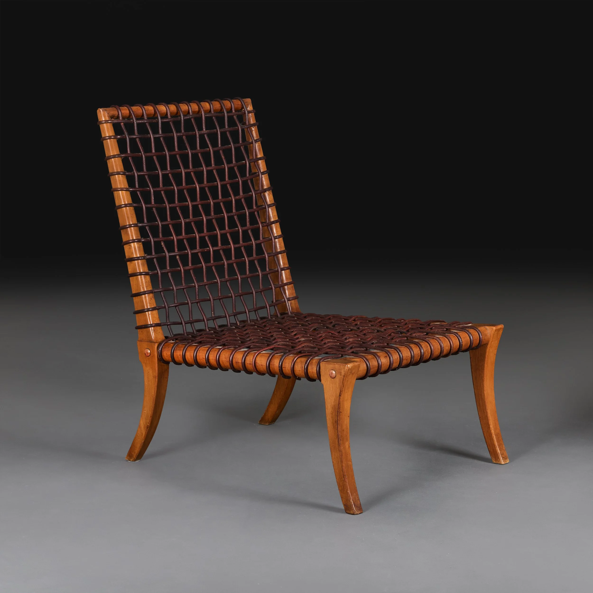A WOVEN LEATHER ARMCHAIR BY T.H. ROBSJOHN-GIBBINGS