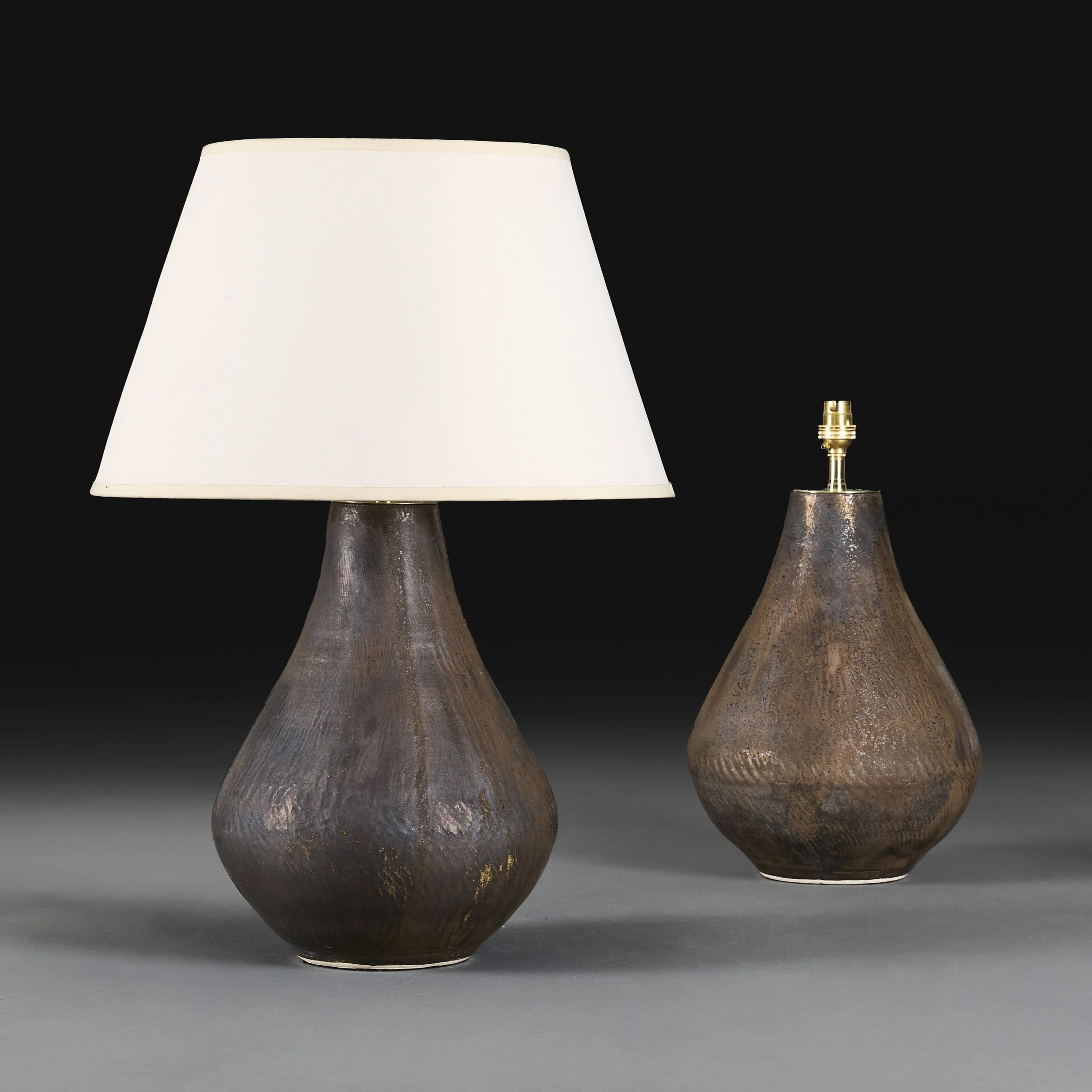 A PAIR OF BRONZE GLAZED ART POTTERY LAMPS