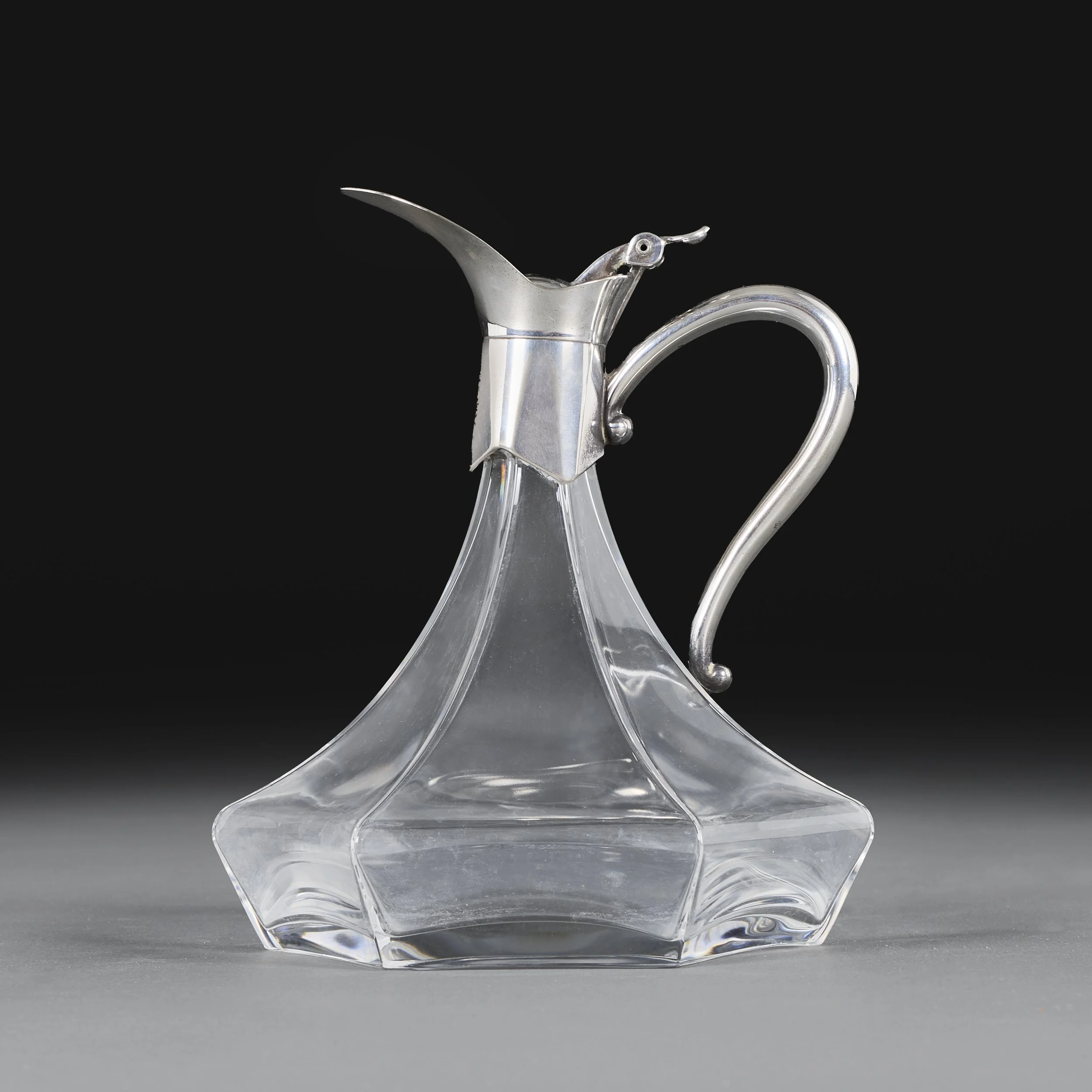 A HEXAGONAL SILVER AND GLASS CLARET JUG