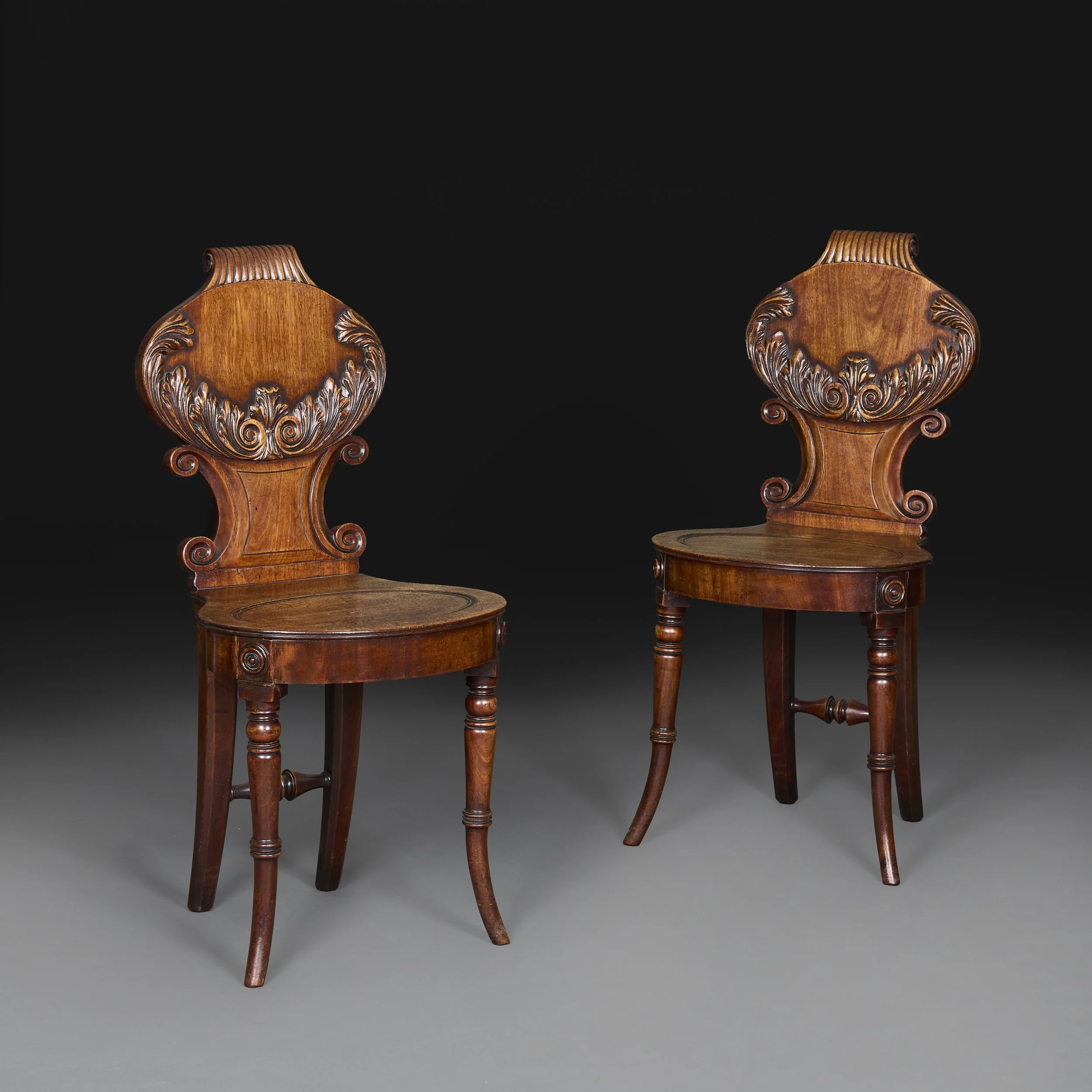 A PAIR OF WILLIAM IV MAHOGANY HALL CHAIRS