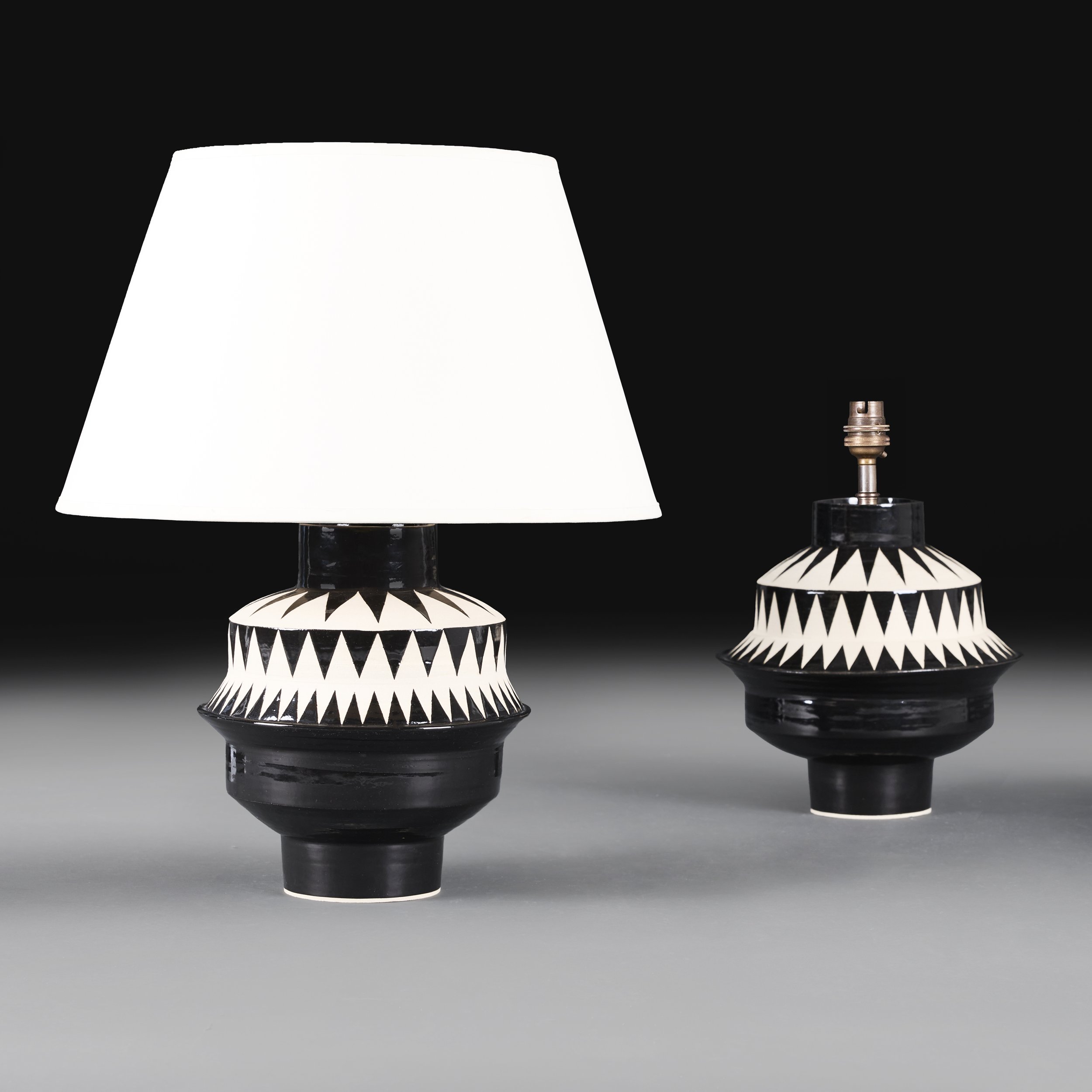 A PAIR OF GEOMETRIC MONOCHROME POTTERY LAMPS