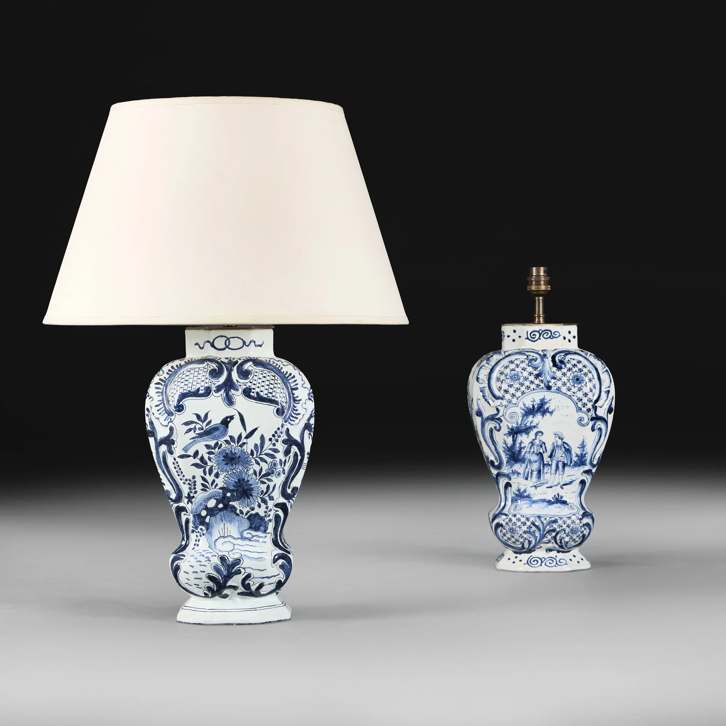 A PAIR OF MATCHED BLUE AND WHITE DELFT LAMPS