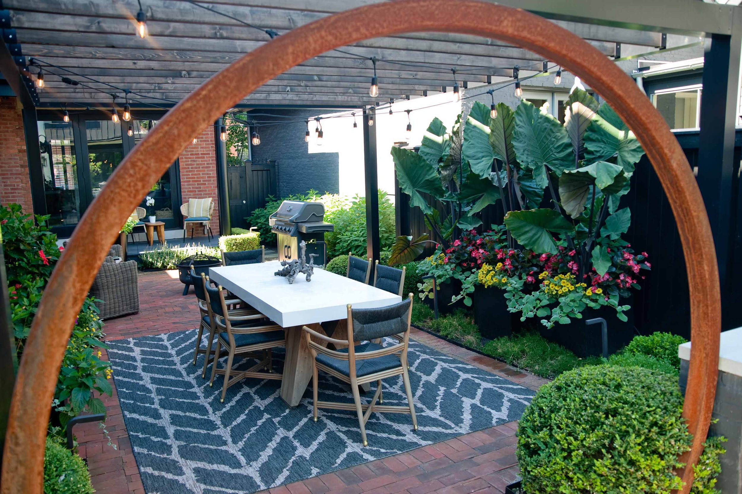 Urban garden with lush tropical pants and outdoor dining