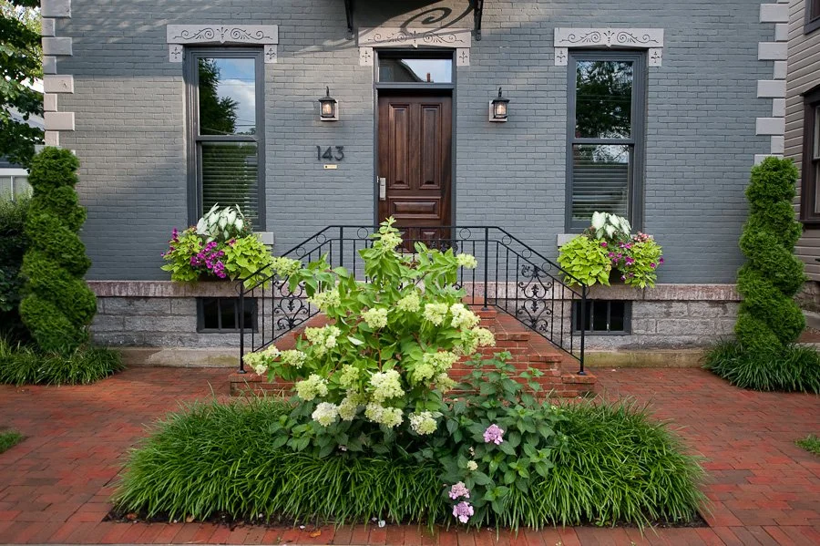 Entry way and sidewalk with custom landscape design