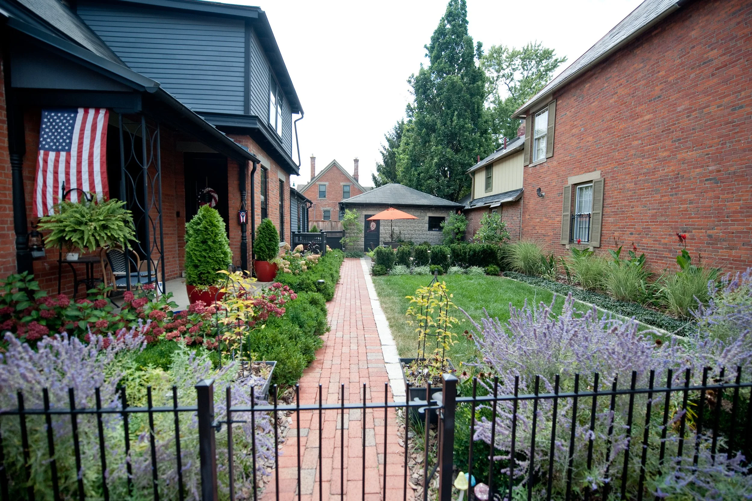 Urban garden design with flowers and a formal lawn.