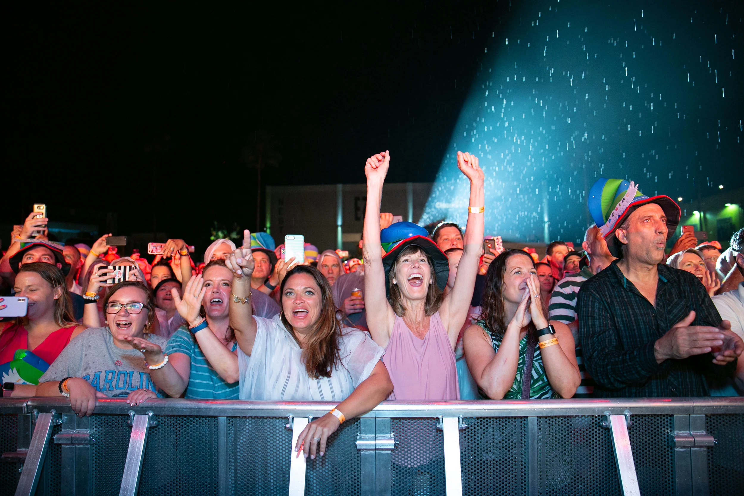  The front row of an excited crowd at a concert 