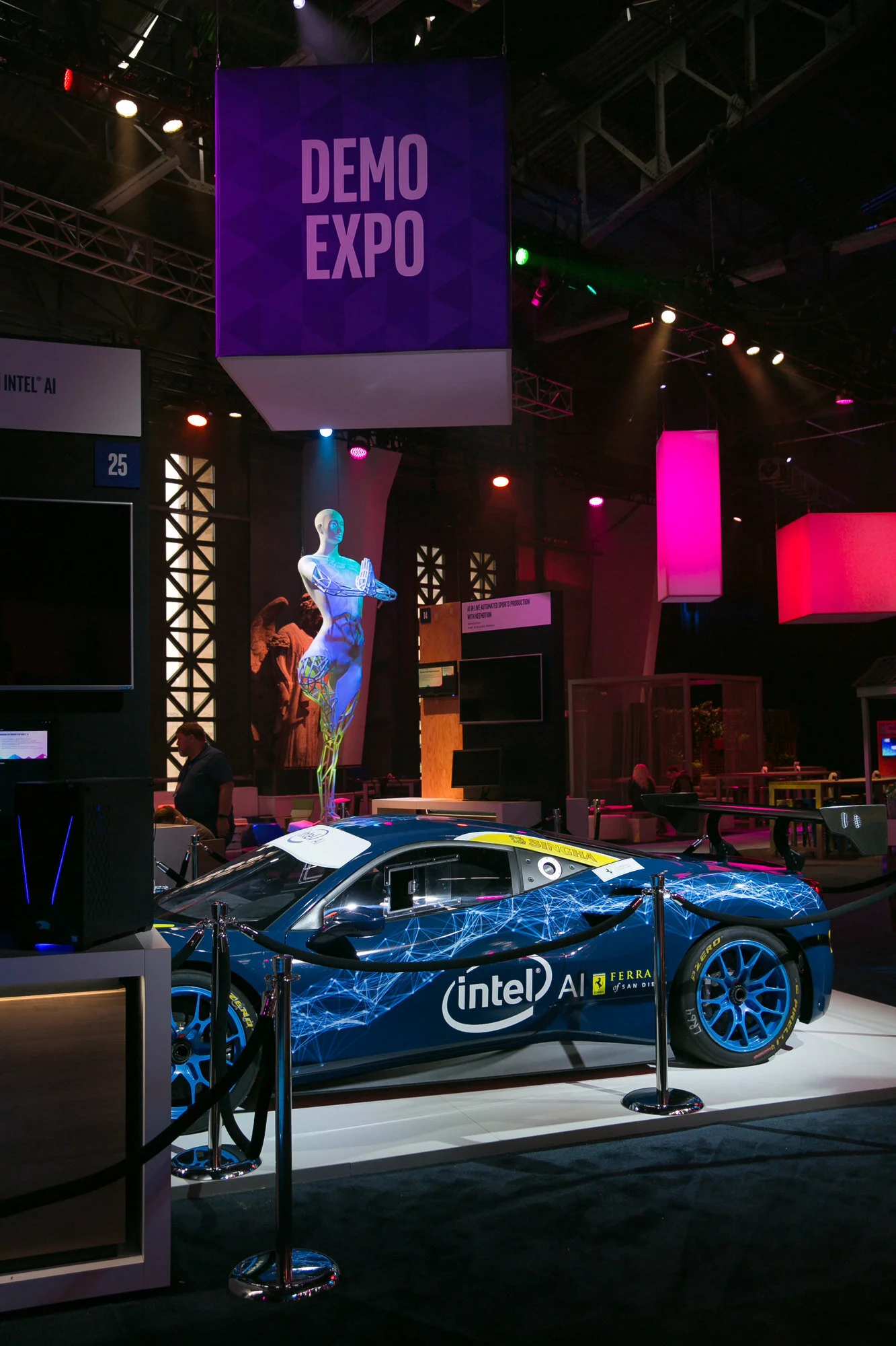  A demo expo spotlights a blue car on display with an Intel decal  