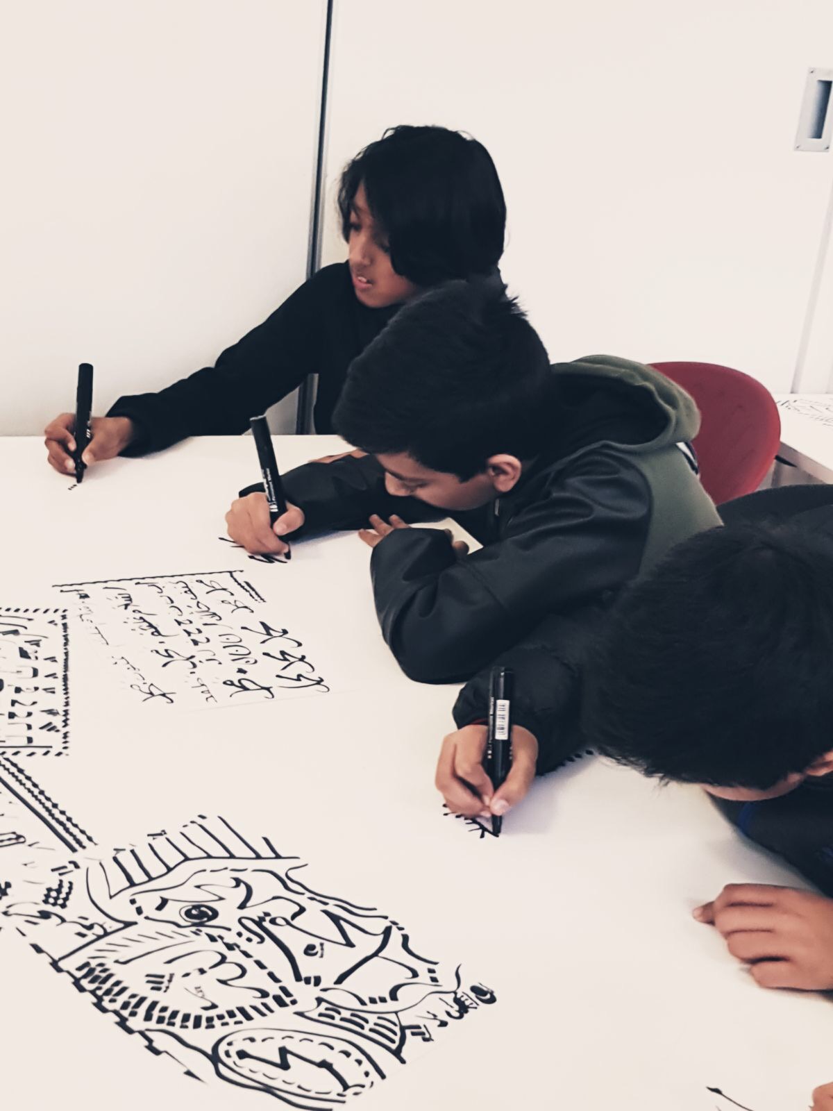 The boys hard at work practising brush strokes