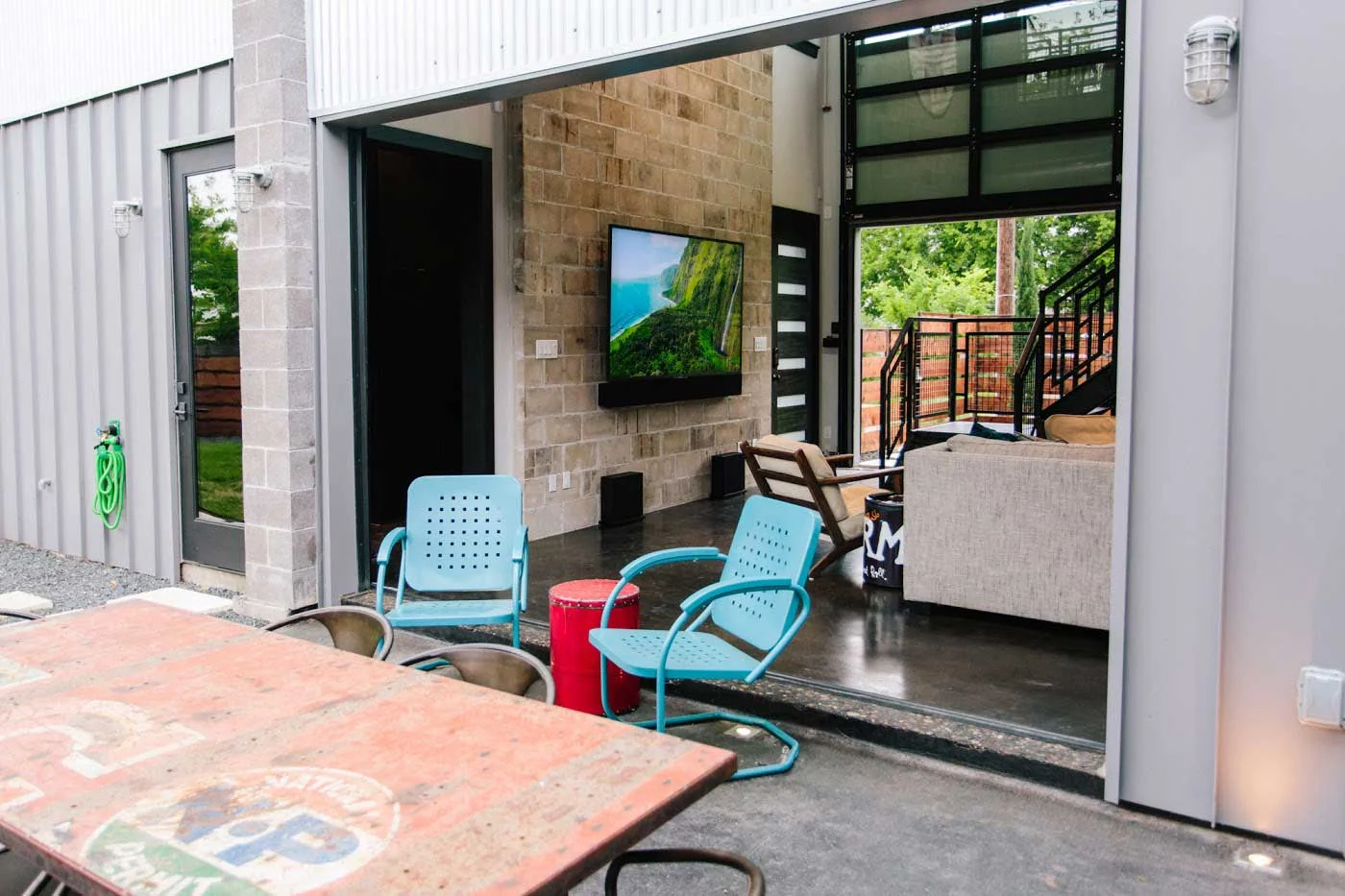 Garage doors open to bring the living space outside