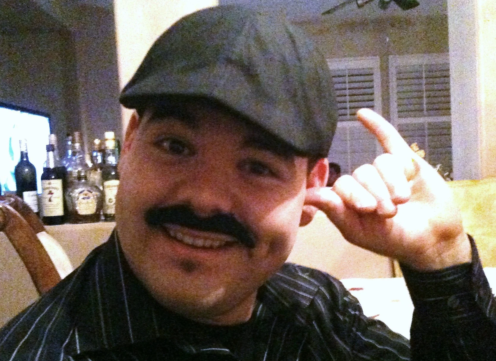 Get that thumb out of your ear, so you can hear all of the compliments on that bitchin' 'Stache!