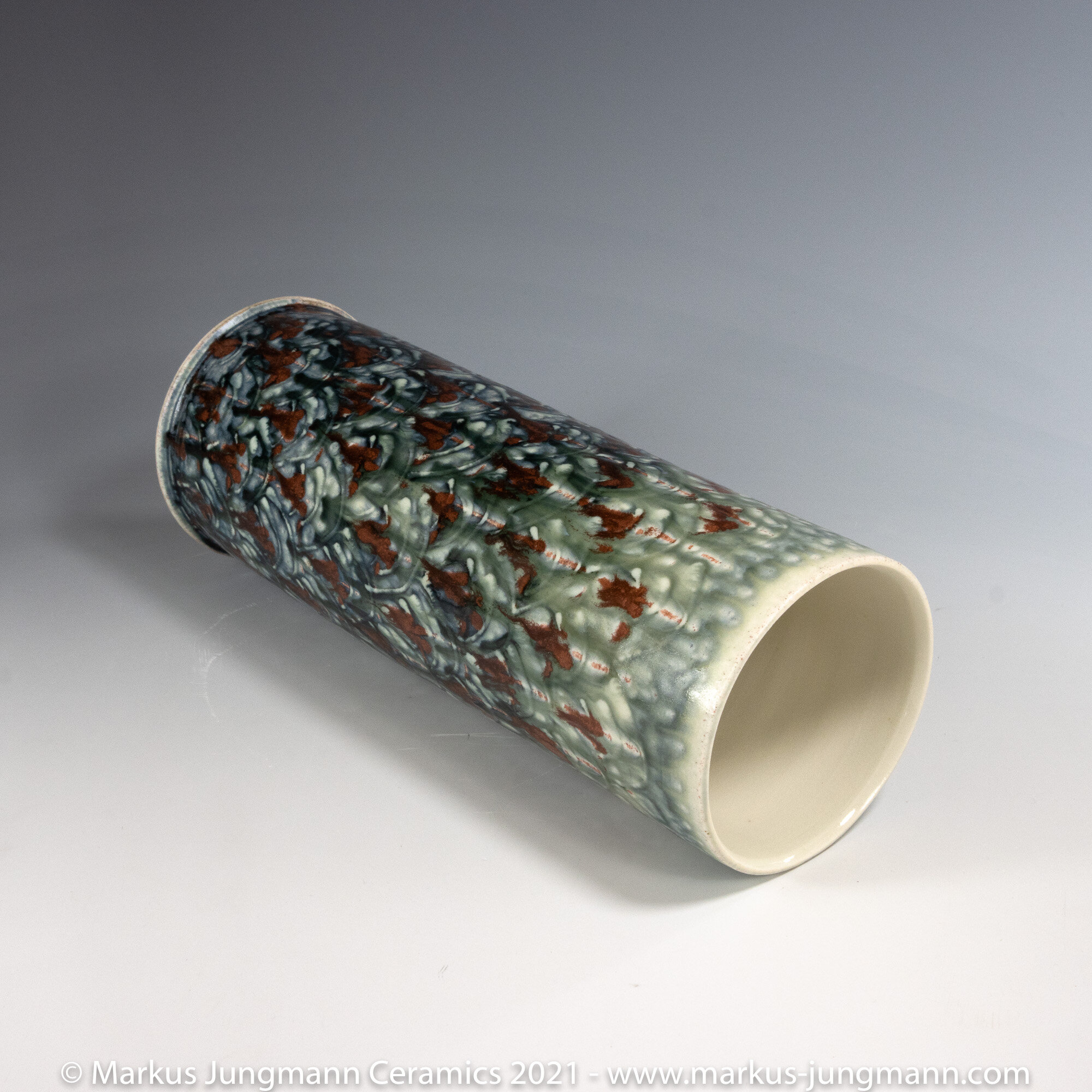 Hand made and hand decorated porcelain vase. Approximately  26 cm high. Beautiful dynamic colour response from a combination of ash and crystalline glazes.