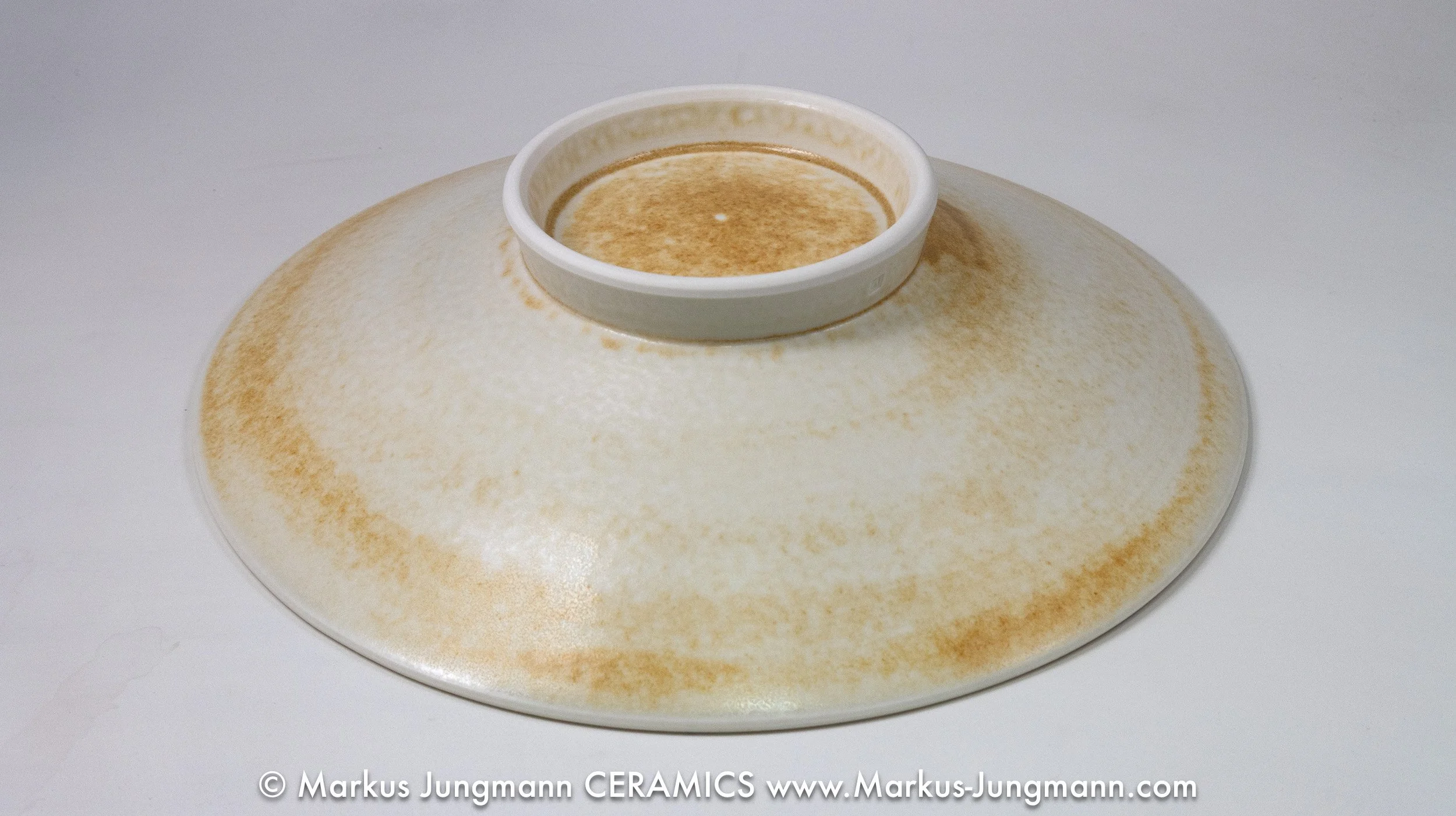 Bottom view, Wheel-thrown porcelain bowl with a teal grid and floral lattice on an oatmeal ground, by Markus Jungmann.