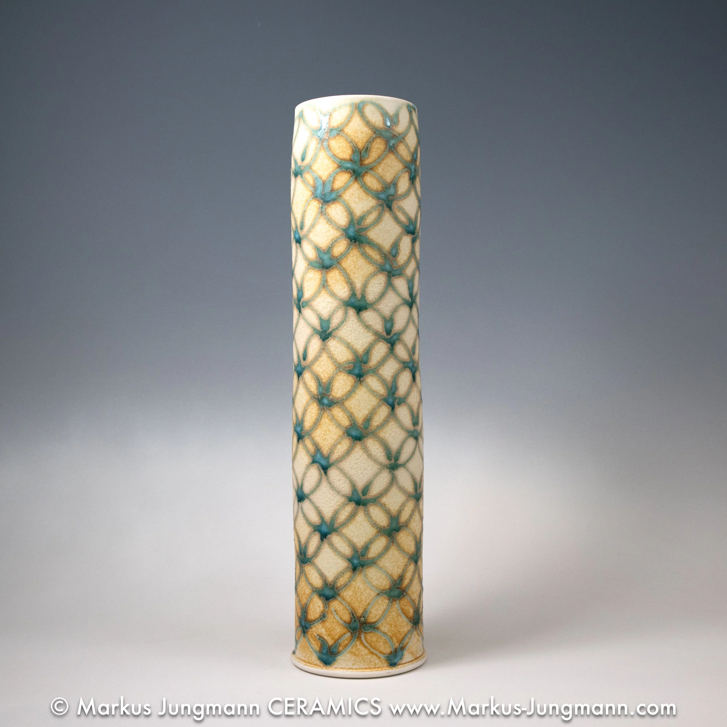 Tall porcelain vase with an interlocking-circle pattern in teal over a sandy ash-glaze ground,  by Markus Jungmann