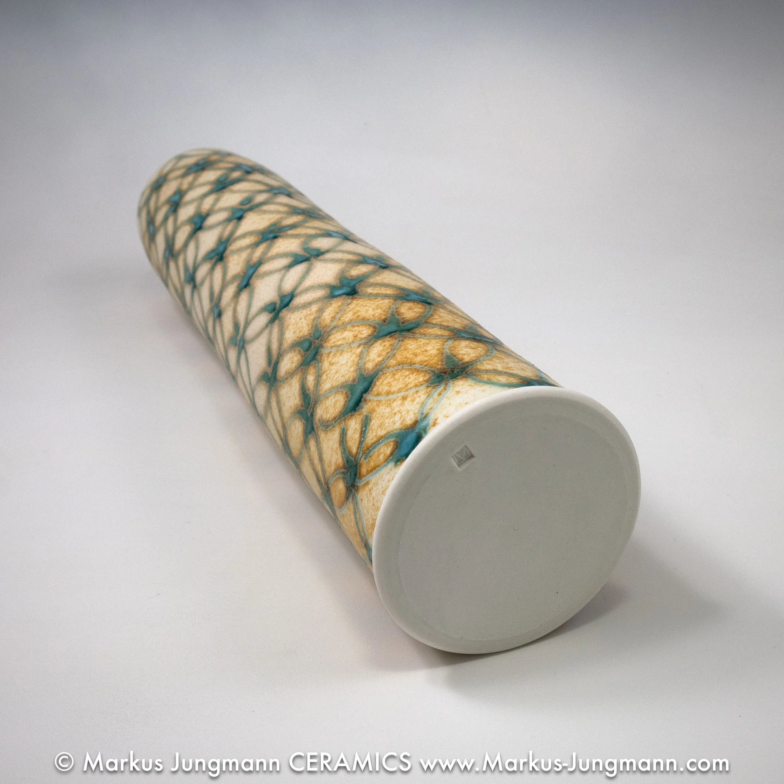 Tall porcelain vase with an interlocking-circle pattern in teal over a sandy ash-glaze ground, bottom, by Markus Jungmann
