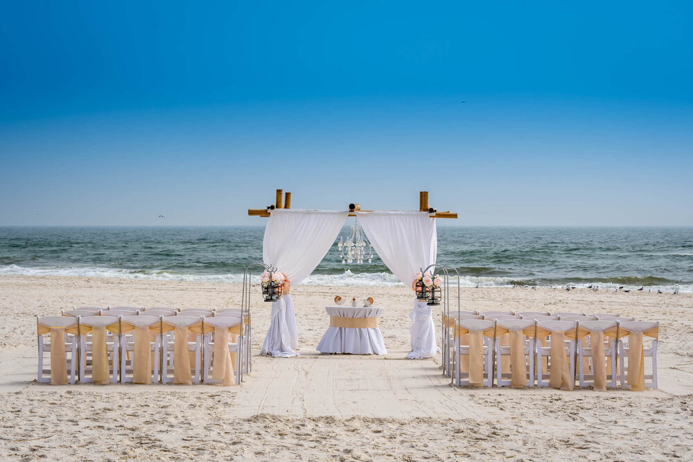 https://images.squarespace-cdn.com/content/v1/597282dd6b8f5bd129c3ae8c/1581951868845-0I9BOMLTD4JYK20B8N76/chairs+and+altar+on+beach+for+beach+wedding.jpg?format=1000w
