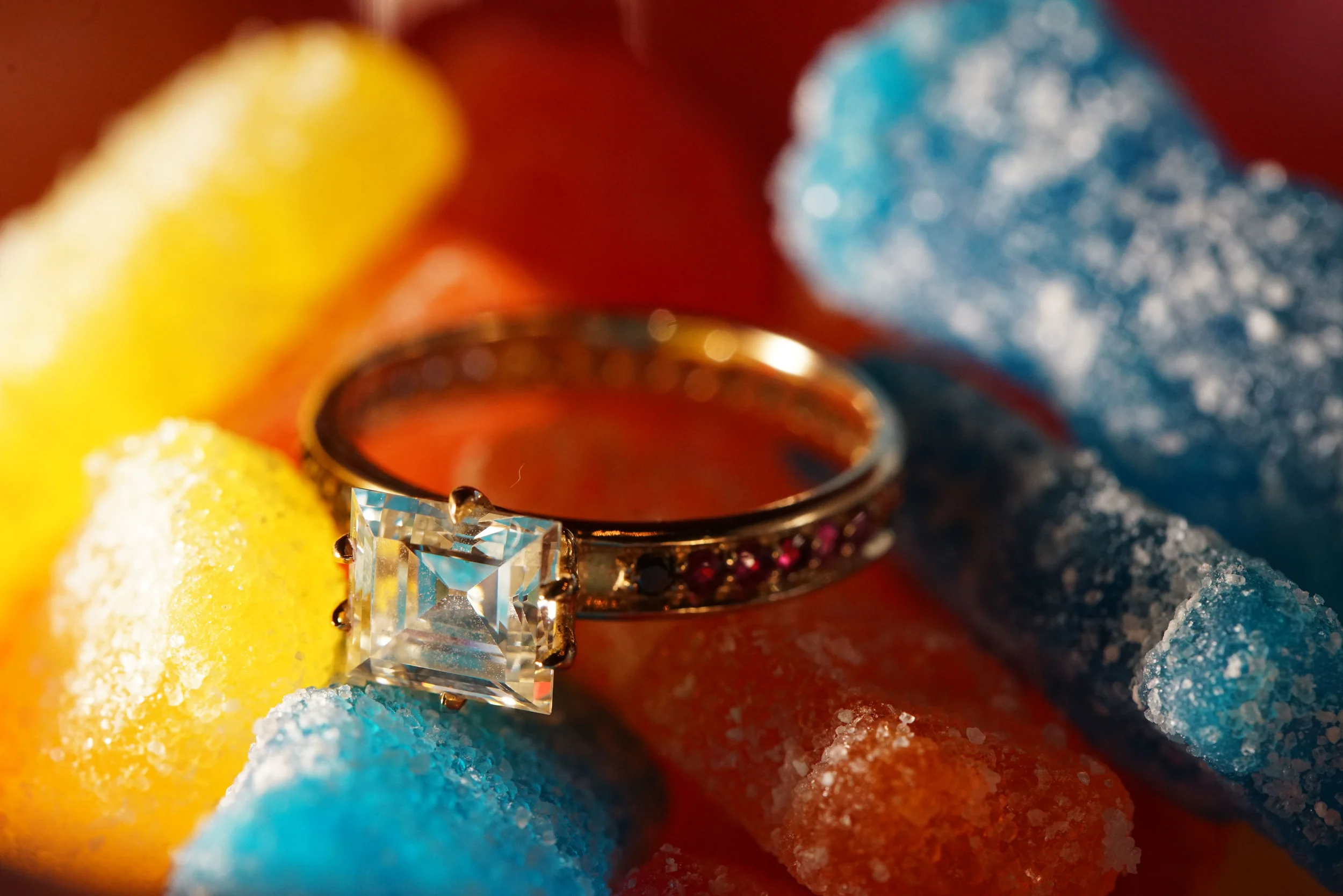  A gorgeous Carre cut diamond set into a rainbow pave band. 