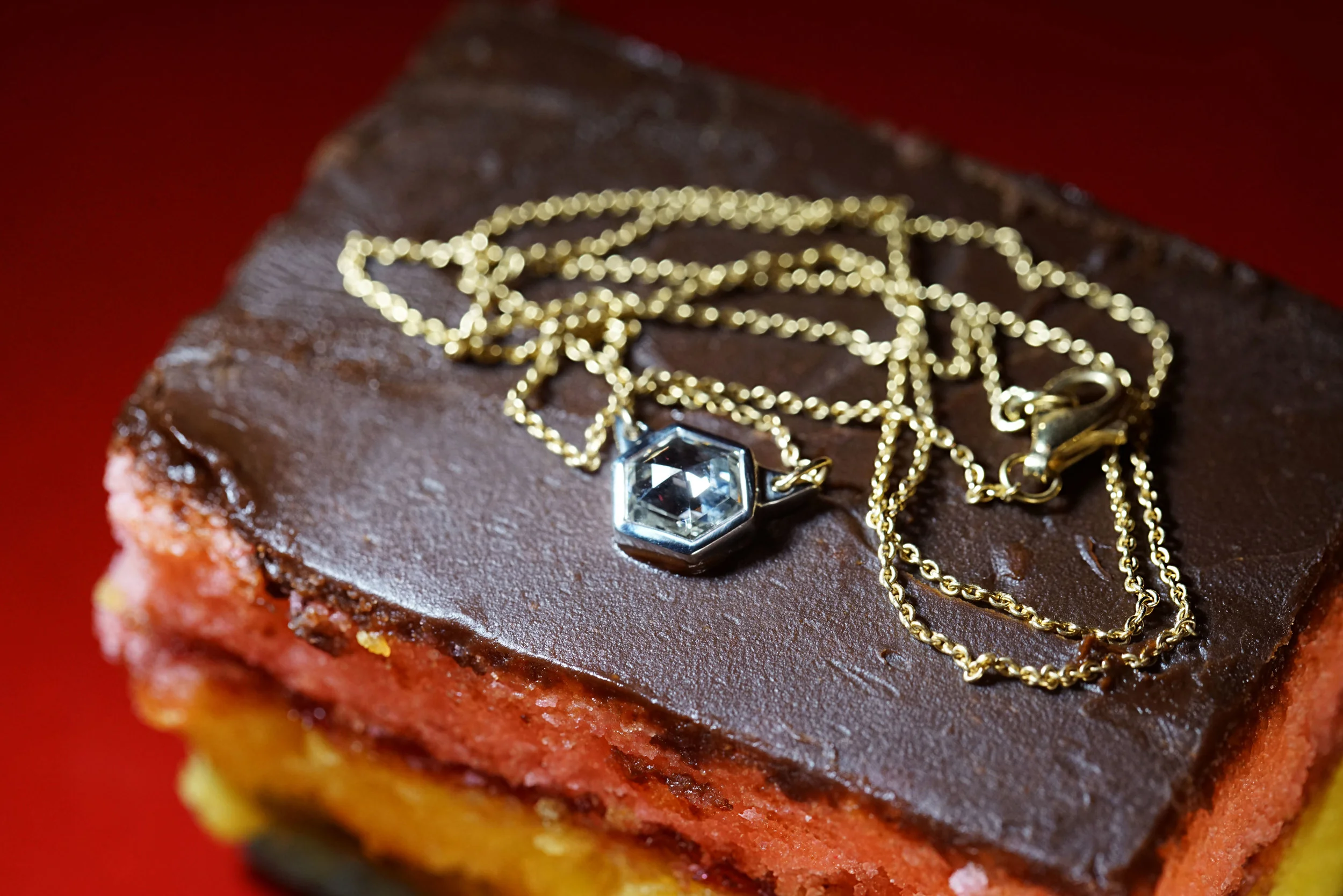  1.16 carats of hexagonal step-cut diamond set upside down in hand-carved platinum on an 18k gold chain. 