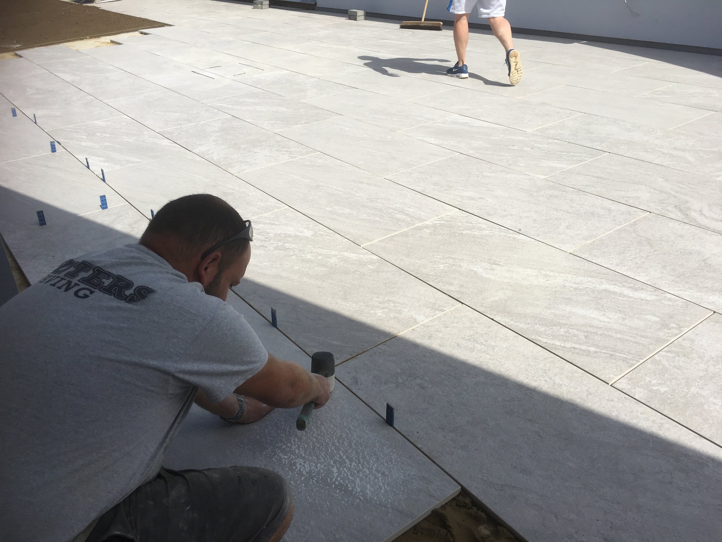 Laying the stunning porcelain paving for this patio, every joint being a specific 5mm joint for pointing.