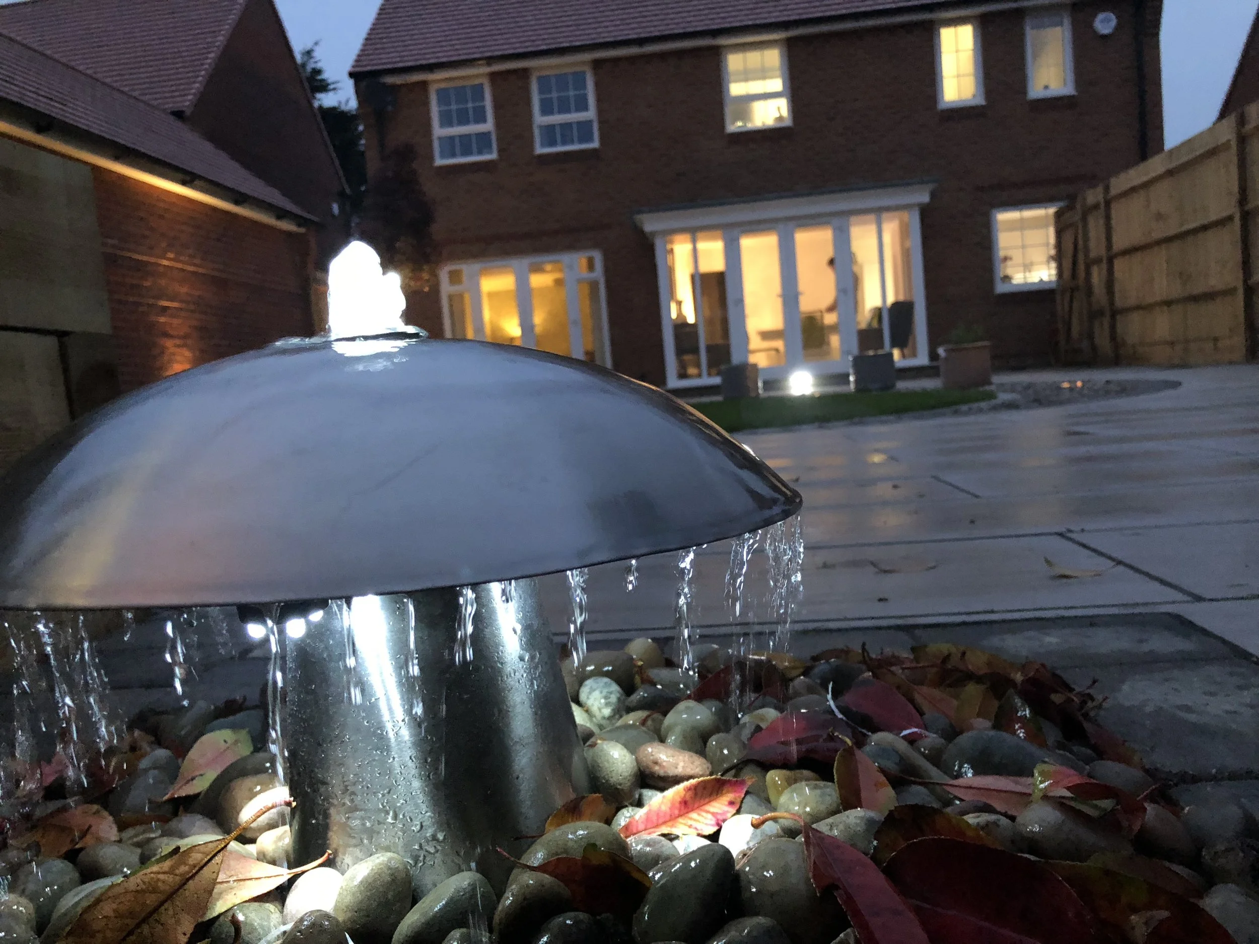 Installing a water feature in this garden with lighting, creating a really nice ambience.