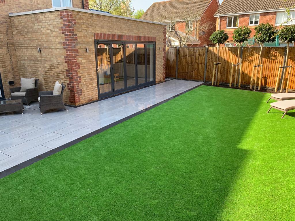 Using the Elegant porcelain in greige with artificial grass, installed in Hambrook near Chichester