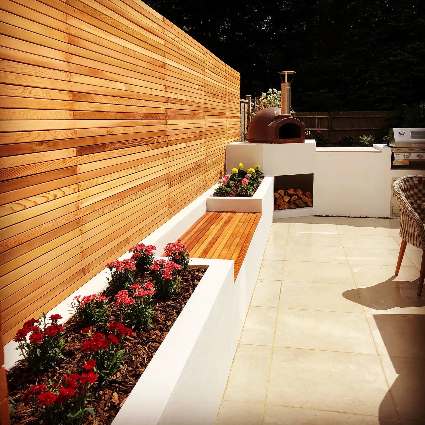 Garden patio with rendered walls and a cedar strip fence installed in Aldwick Bognor regis,