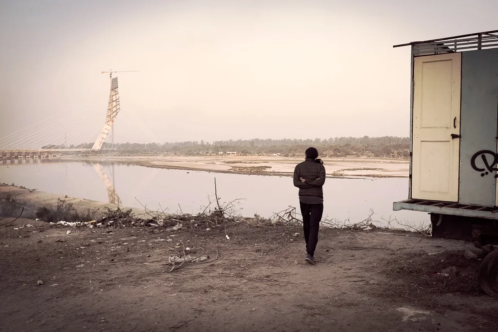 Bhushan carefully inspecting the construction progress of a new bridge across the Yamuna river.