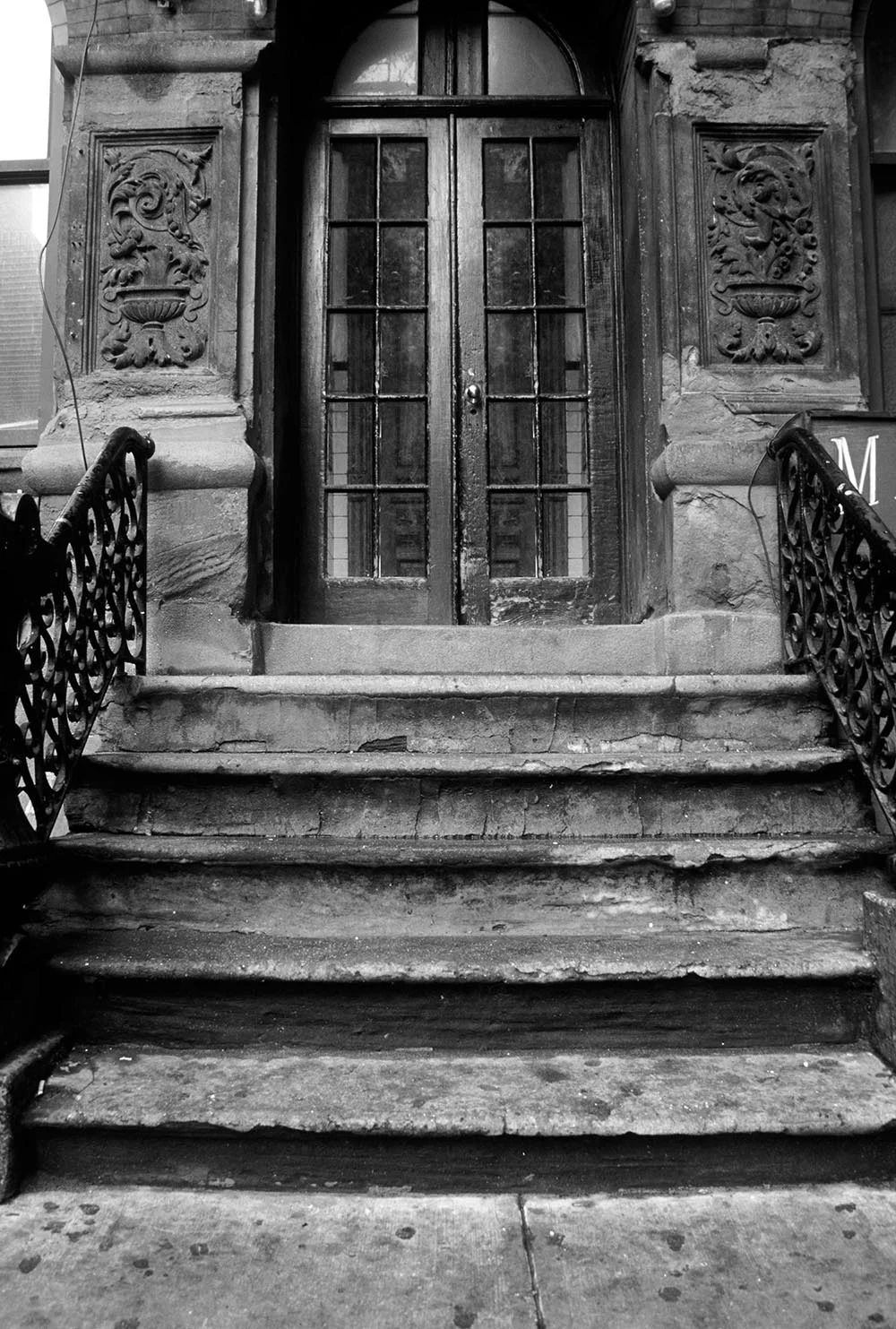 Black and white photograph of a stoop on MacDougal Street.